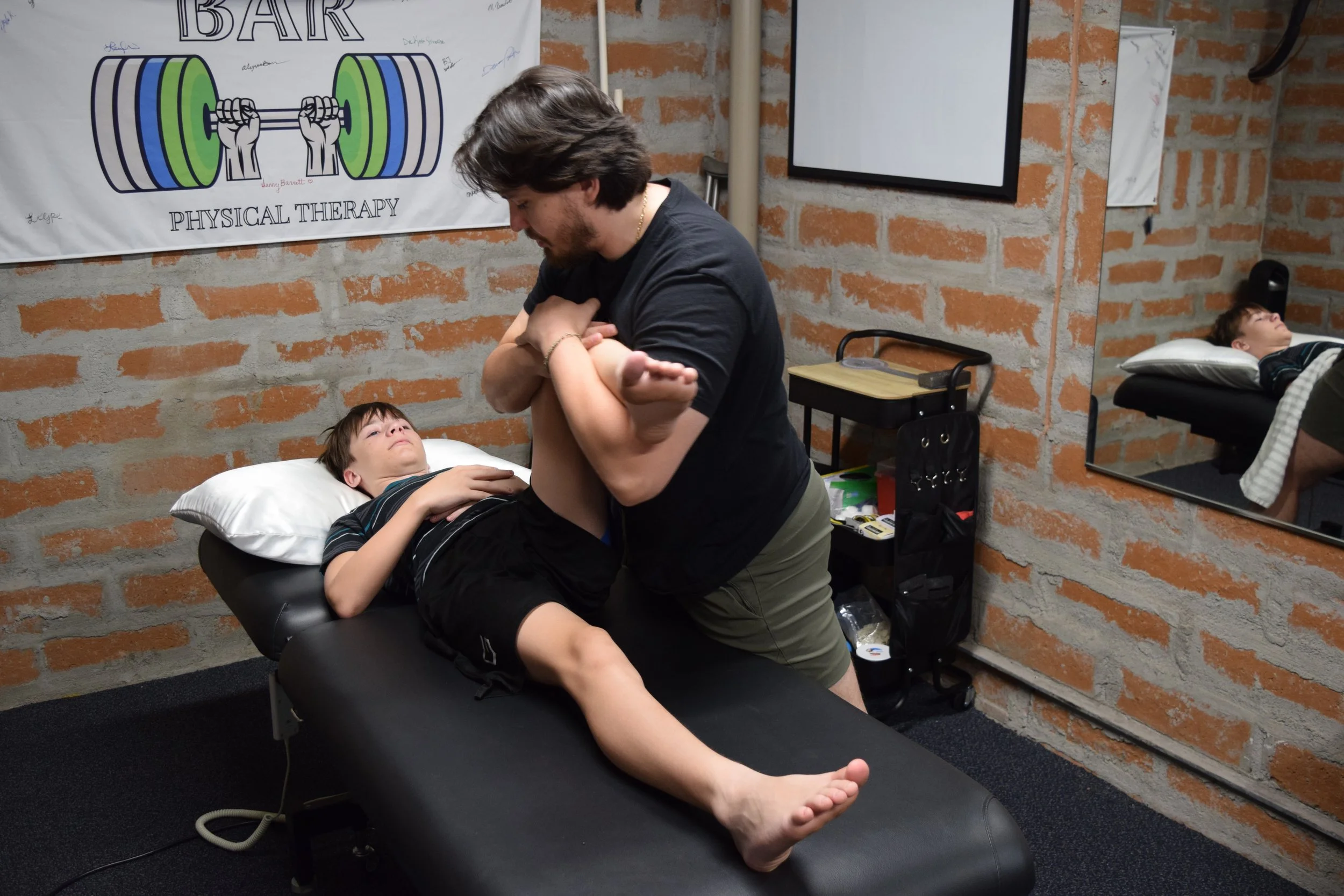 Dr. Connor assessing pediatric patient mobility