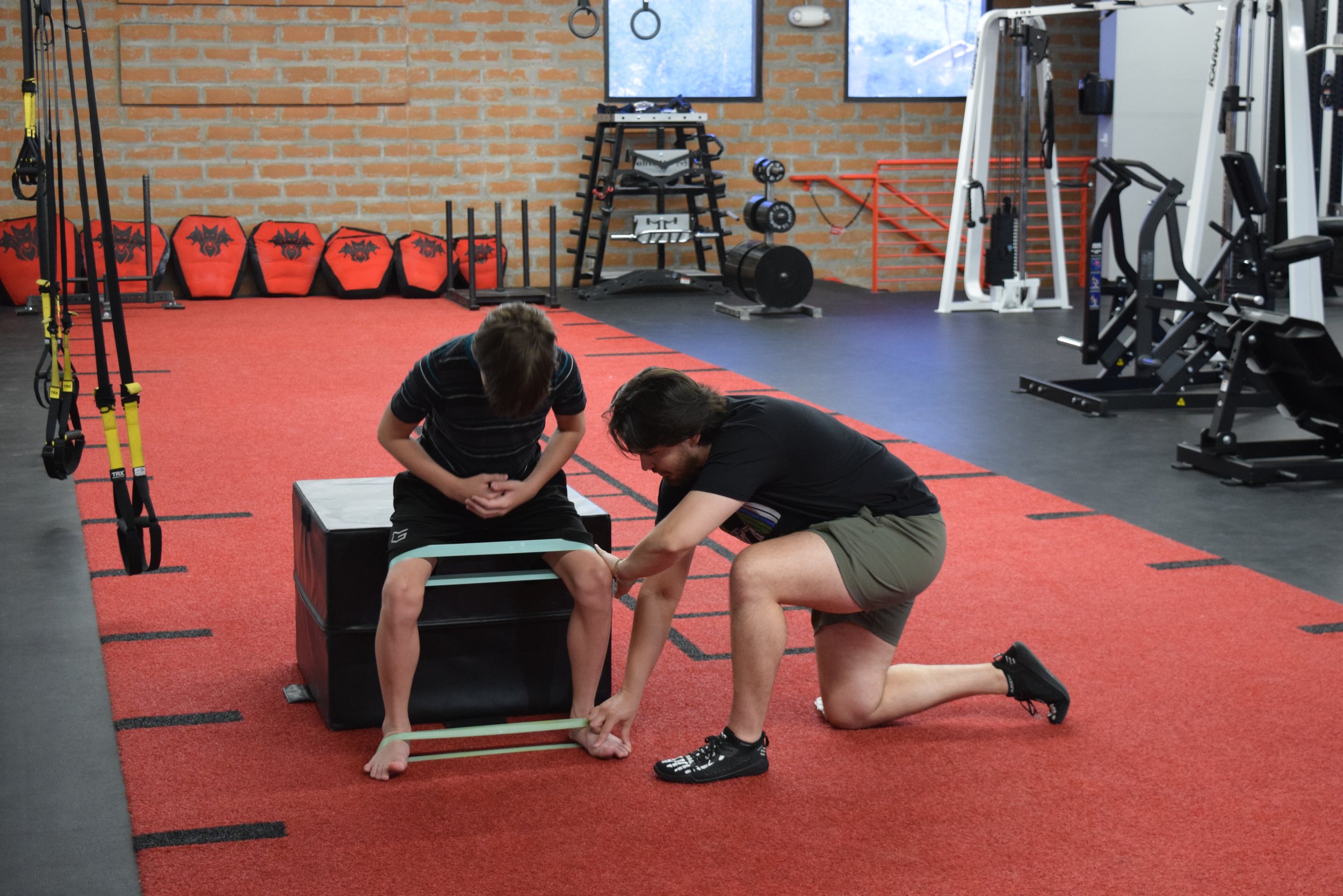 Pediatric patient working on coordination of a squat movement pattern