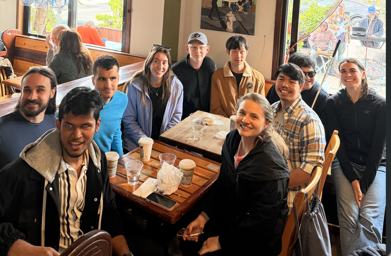 10 people sit around a table at Java Beach Cafe
