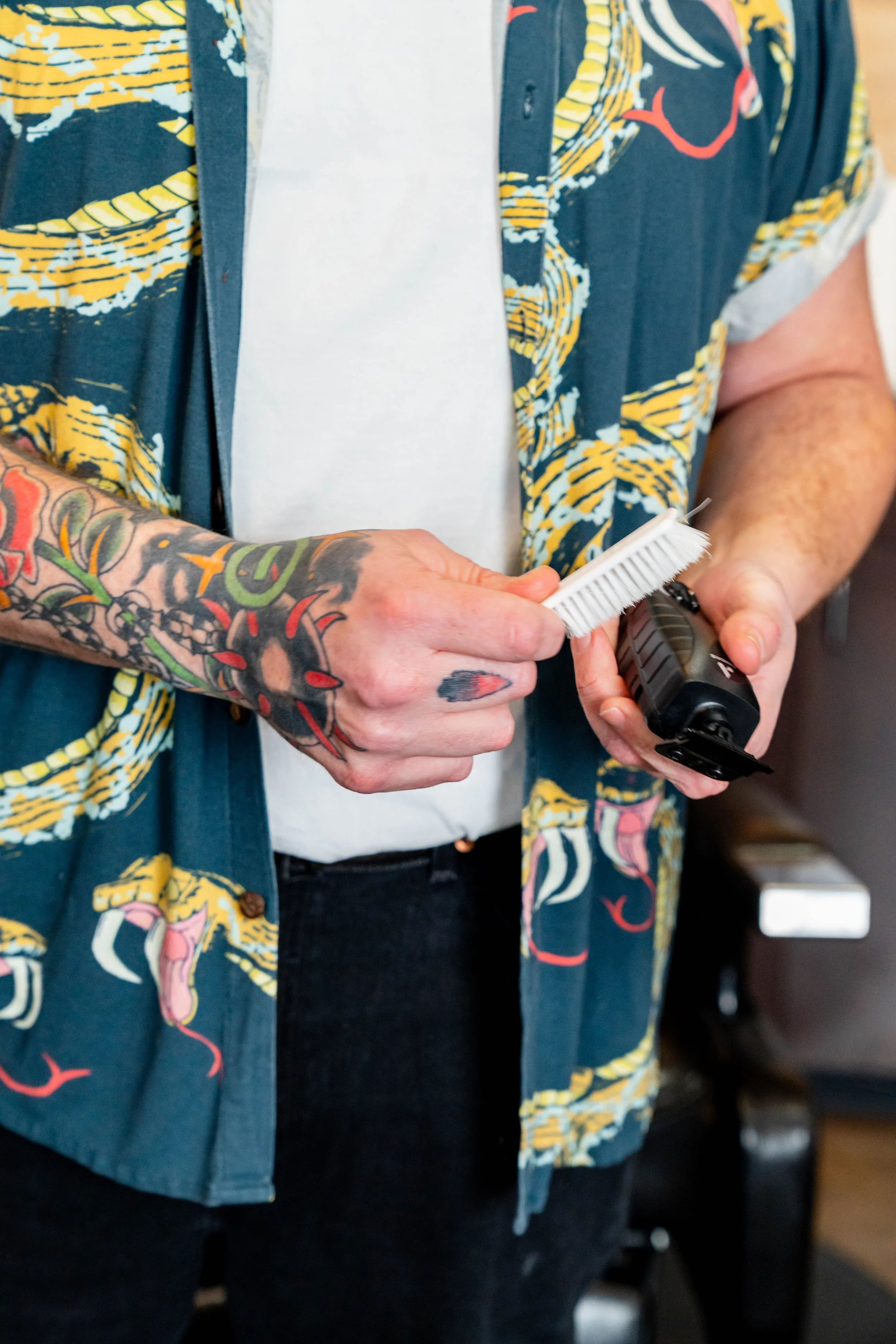Barber preparing tools for haircut service at Rebel Hearts Barbering in Brookside, Kansas City