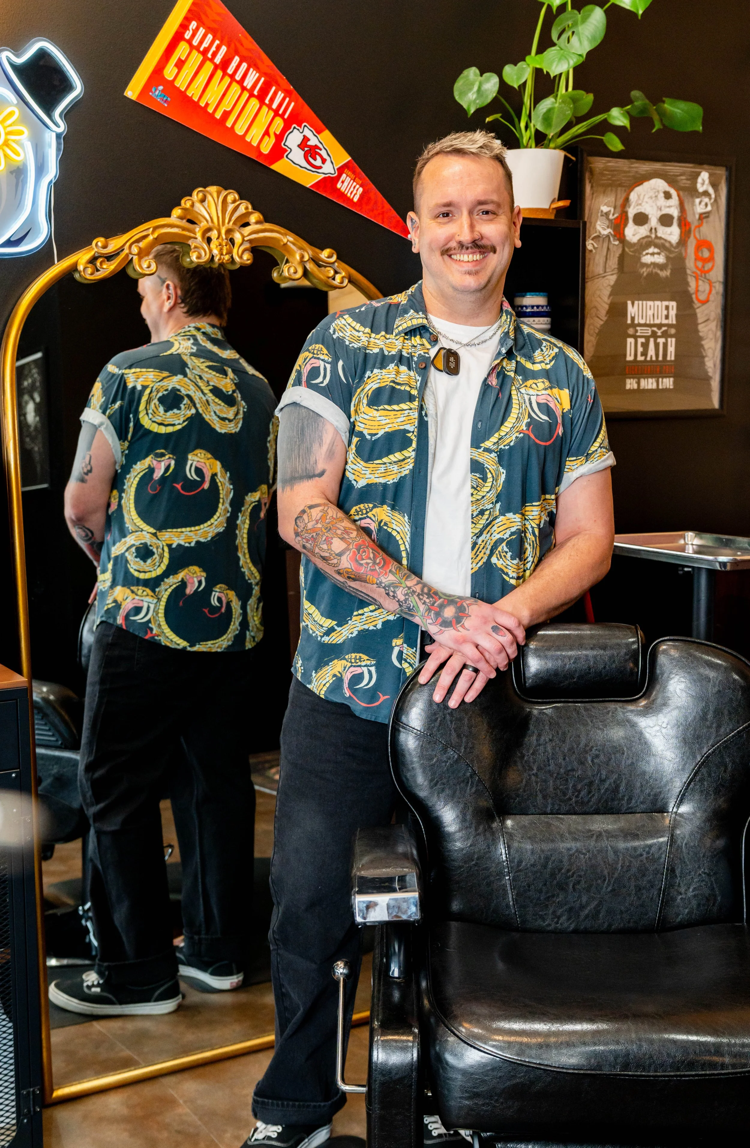 Will Boyer standing in barber chair station at Rebel Hearts Barbering in Brookside, Kansas City