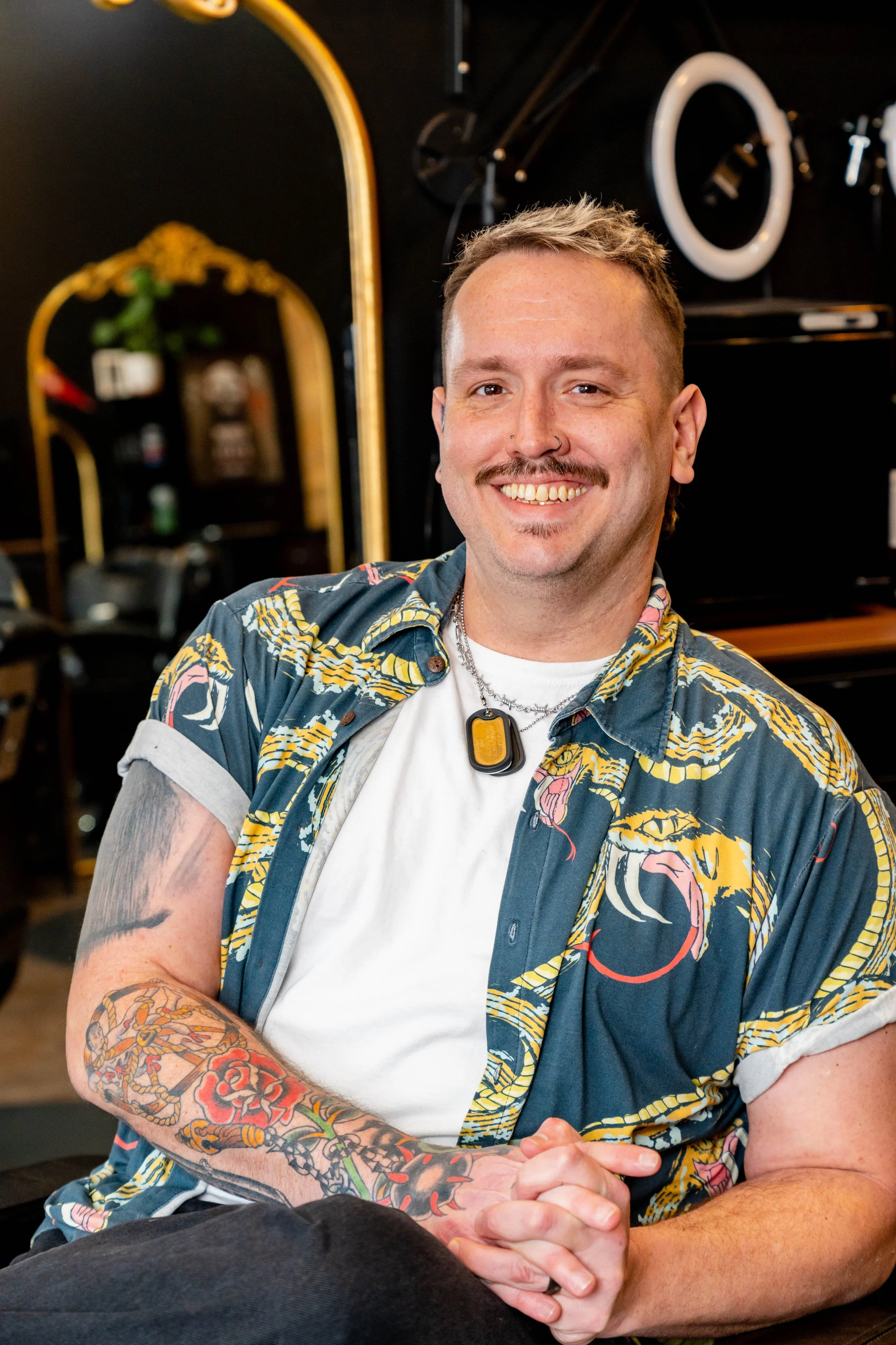 Will Boyer, barber and owner specializing in precision haircuts, fades, and straight razor shaves at Rebel Hearts Barbering in Brookside, Kansas City