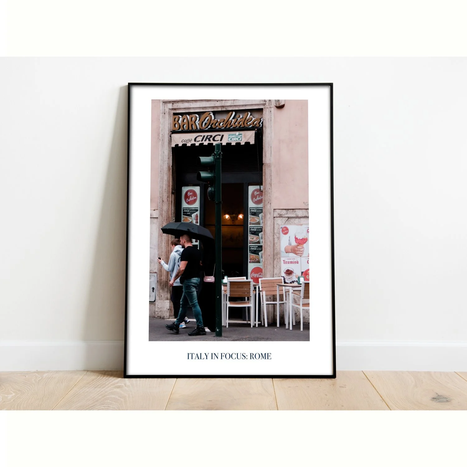 The poster entitled Italy in Focus: Rome is framed and sitting on the floor.