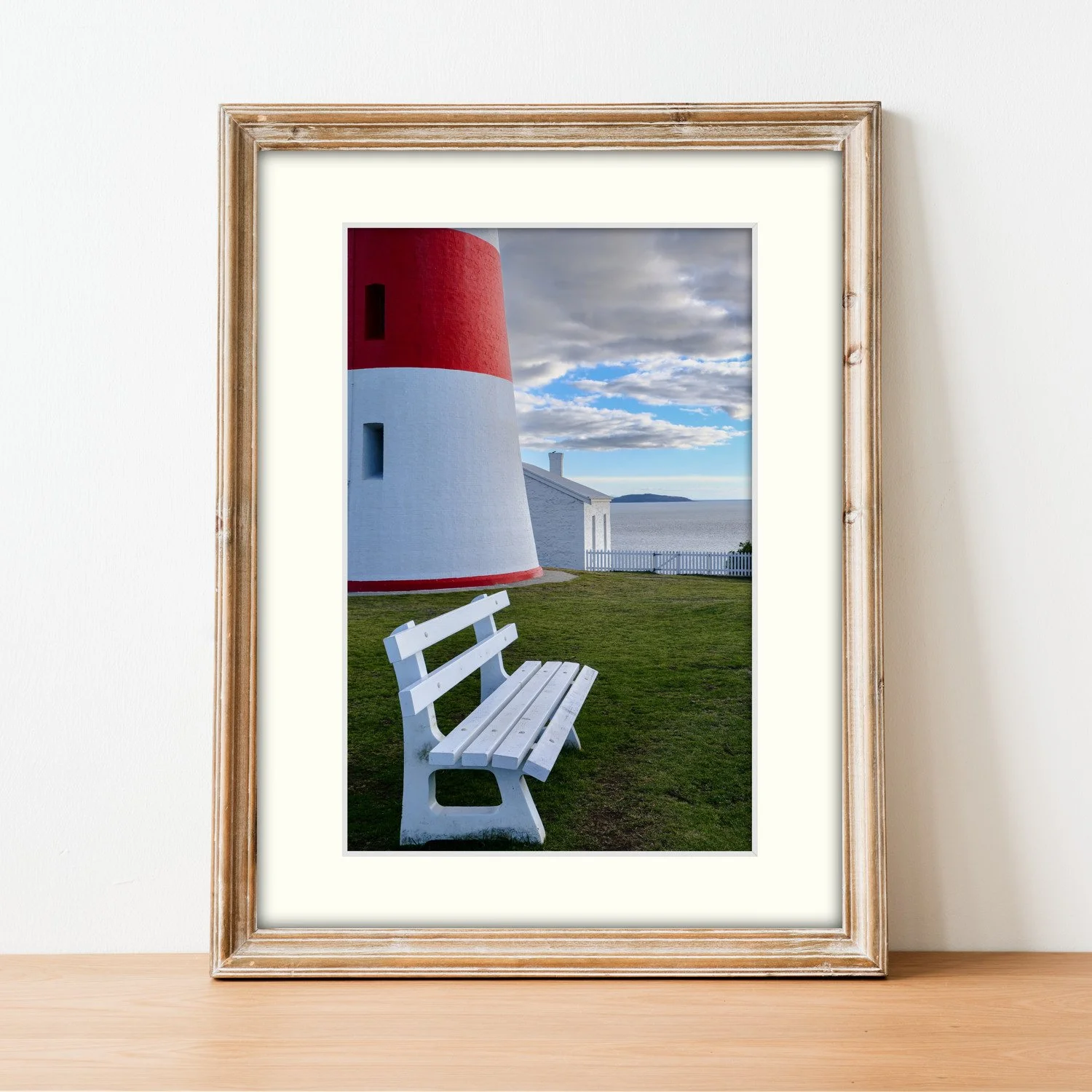 The Low Head Sentinel print and mount framed and sitting stylishly on a sideboard.