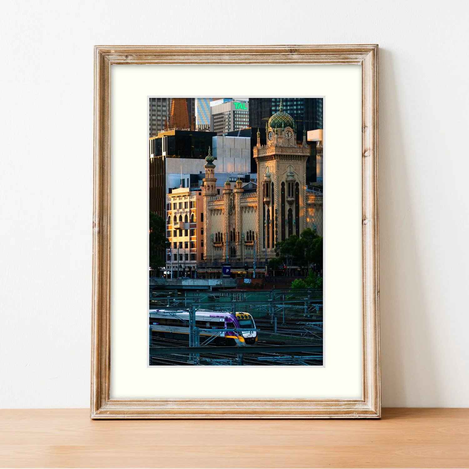 Frame mount with print of Forum Facade in finalised picture frame sitting on sideboard.