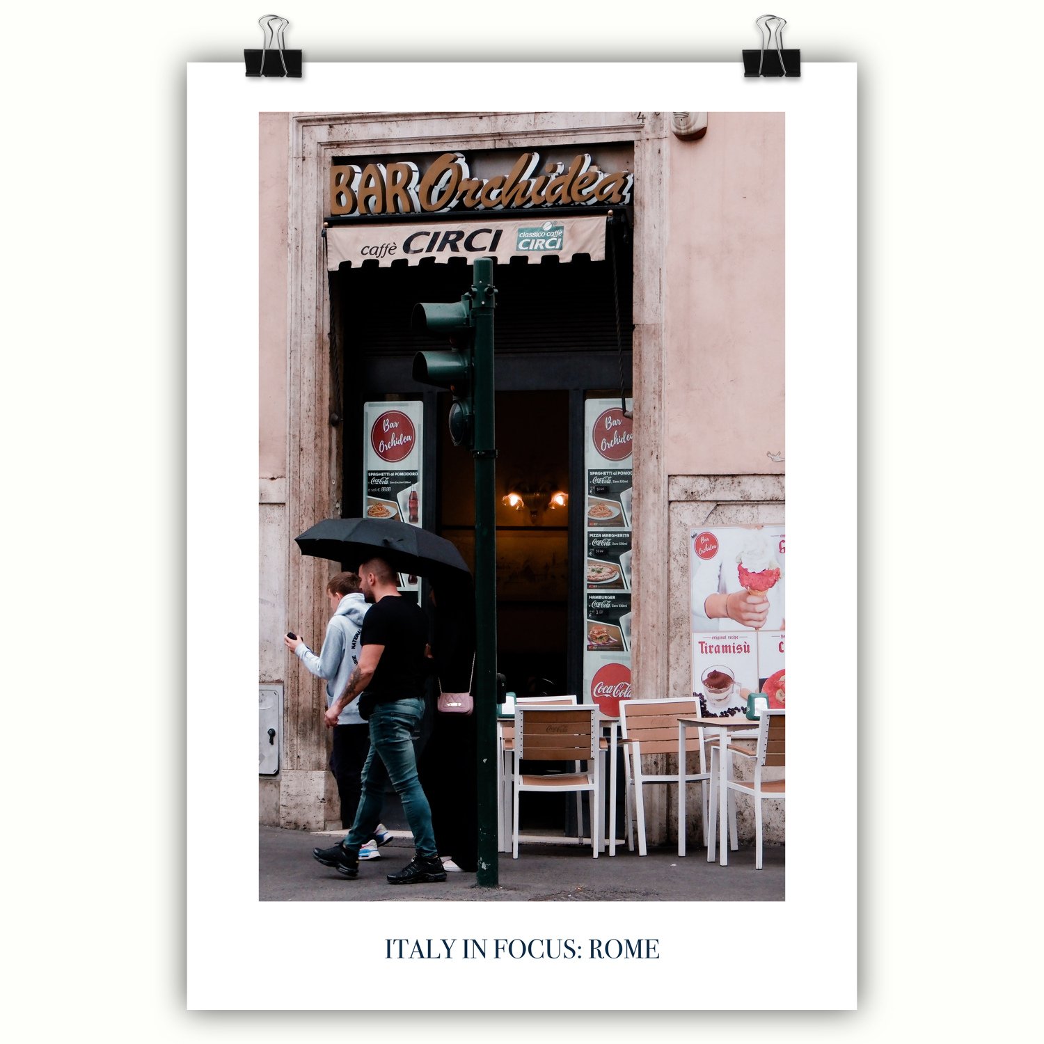A poster featuring a couple walking past a café named "Bar Orchidea" in Rome, with food and drink posters visible on the storefront.