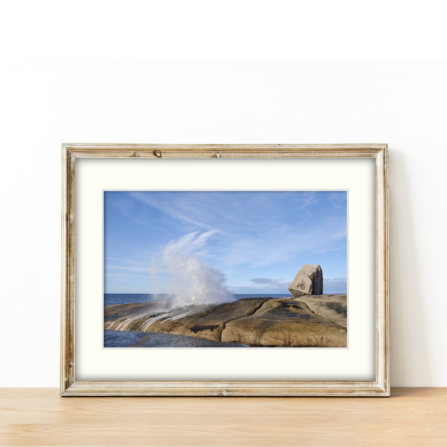 Frame mount with print of Spray Meets Sky in finalised picture frame sitting on sideboard.