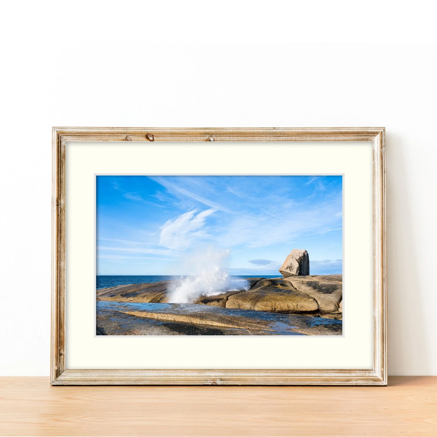 Frame mount with print of Coastal Echo in finalised picture frame sitting on a modern sideboard.