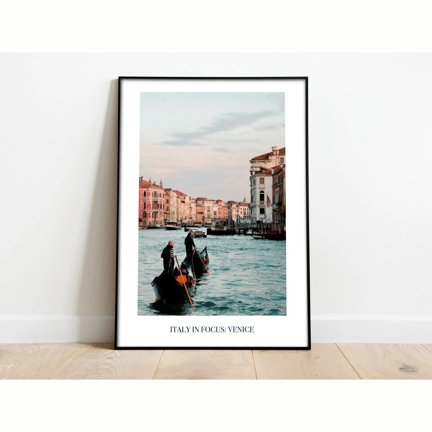 The poster entitled Italy in Focus: Venice is framed and sitting on the floor.