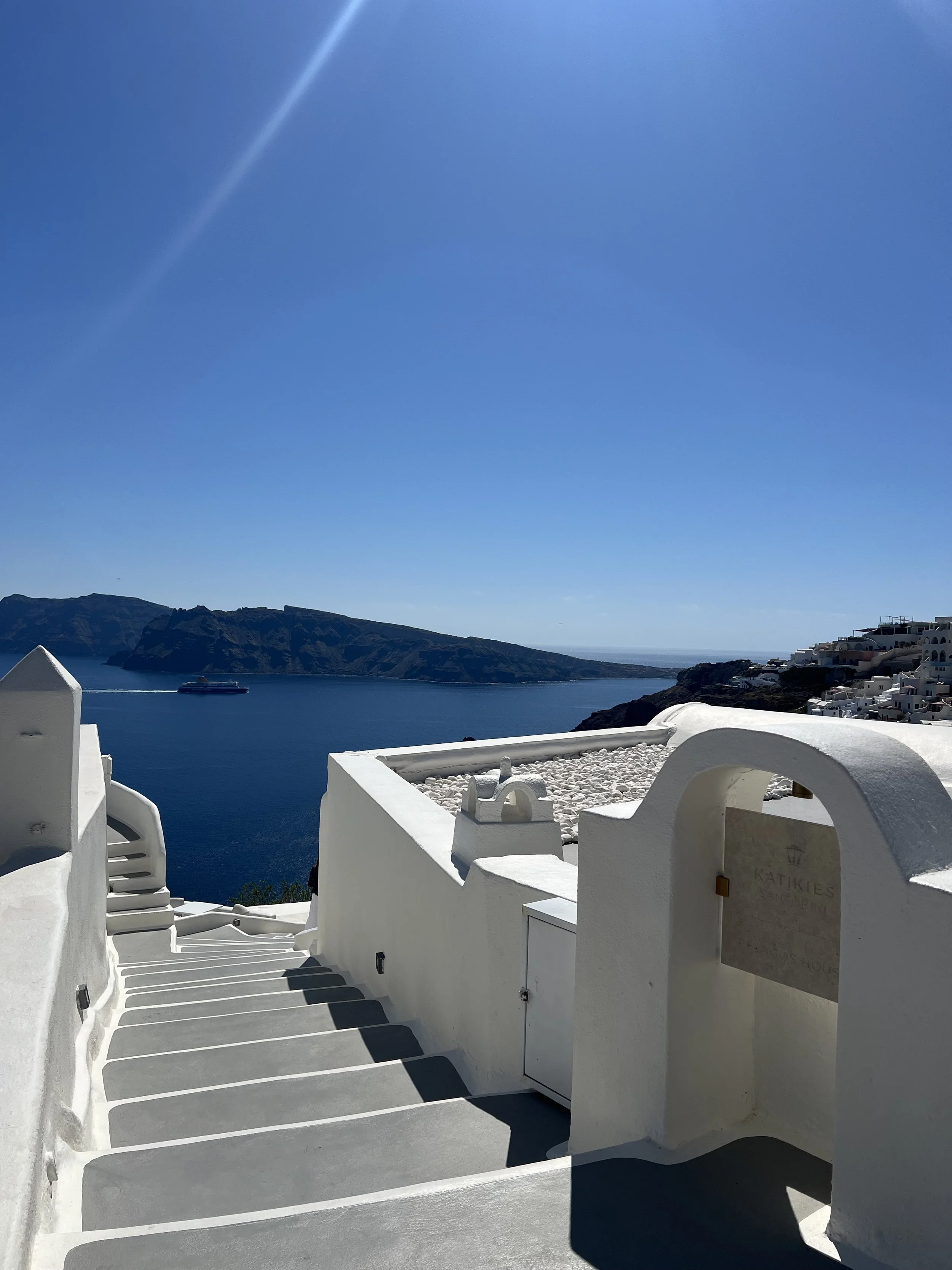 Panoramic view of Santorini, Greece by the entrance of a luxury hotel recommended by Travel by Angela