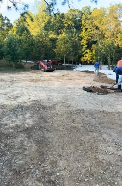 Before sod installation in McMinnville, TN — crew grading and preparing the ground for new grass installation.