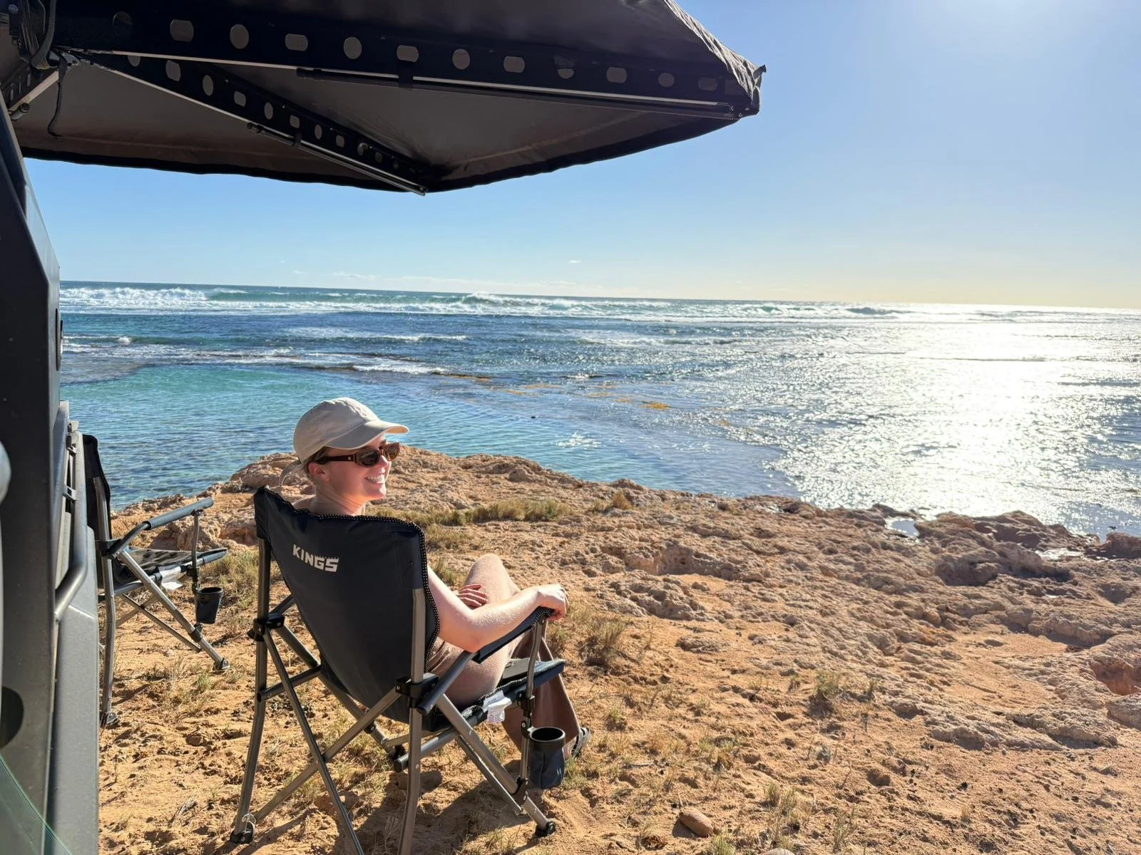 Adventure-ready 4WD rental parked on a red dirt ridge in Western Australia, fully equipped for long-distance outback touring and rugged road trips.