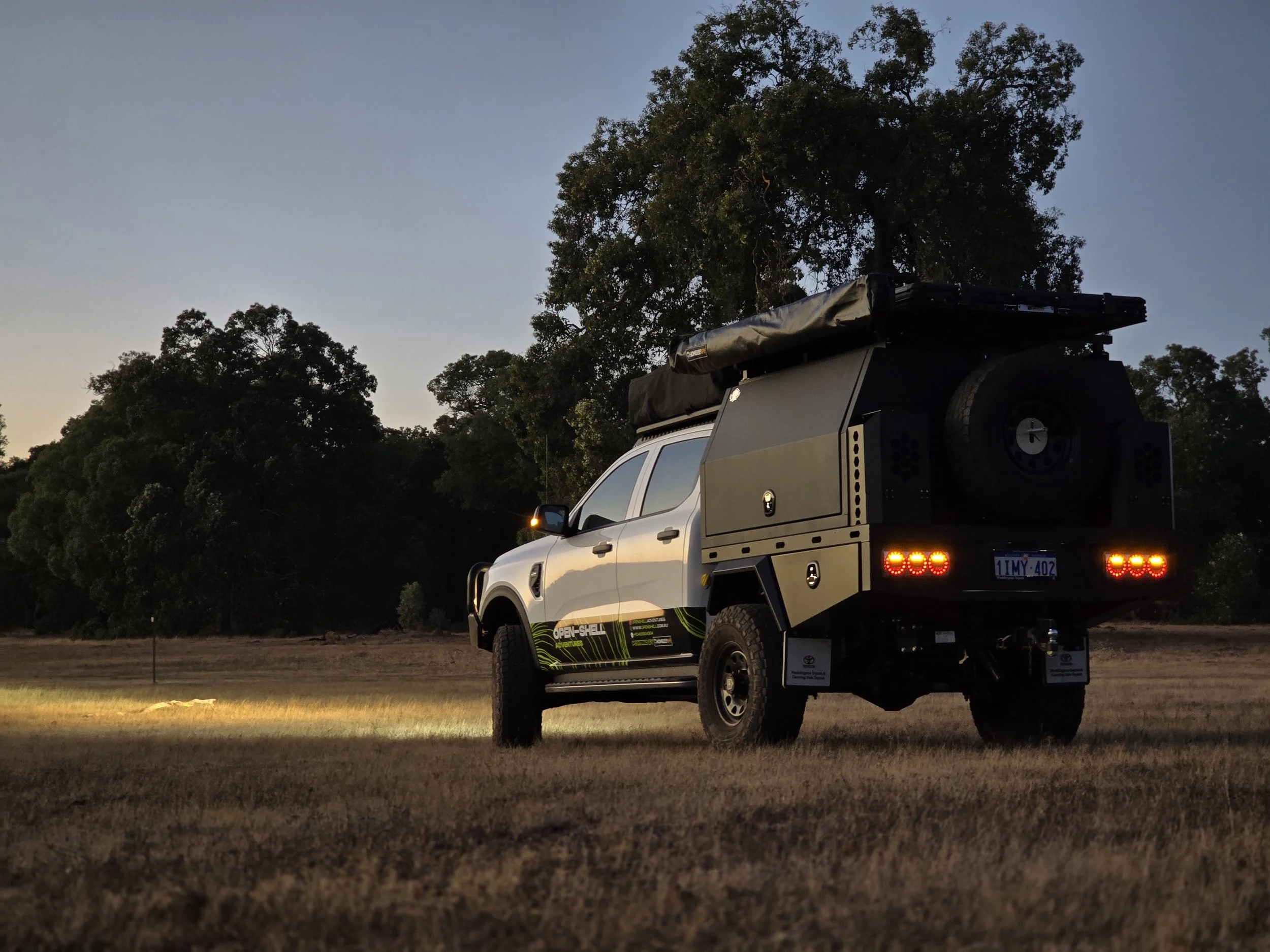 Rooftop tent and awning deployed at a quiet WA lakeside camp — showcasing the convenience of Open Shell’s fully equipped camper rentals.