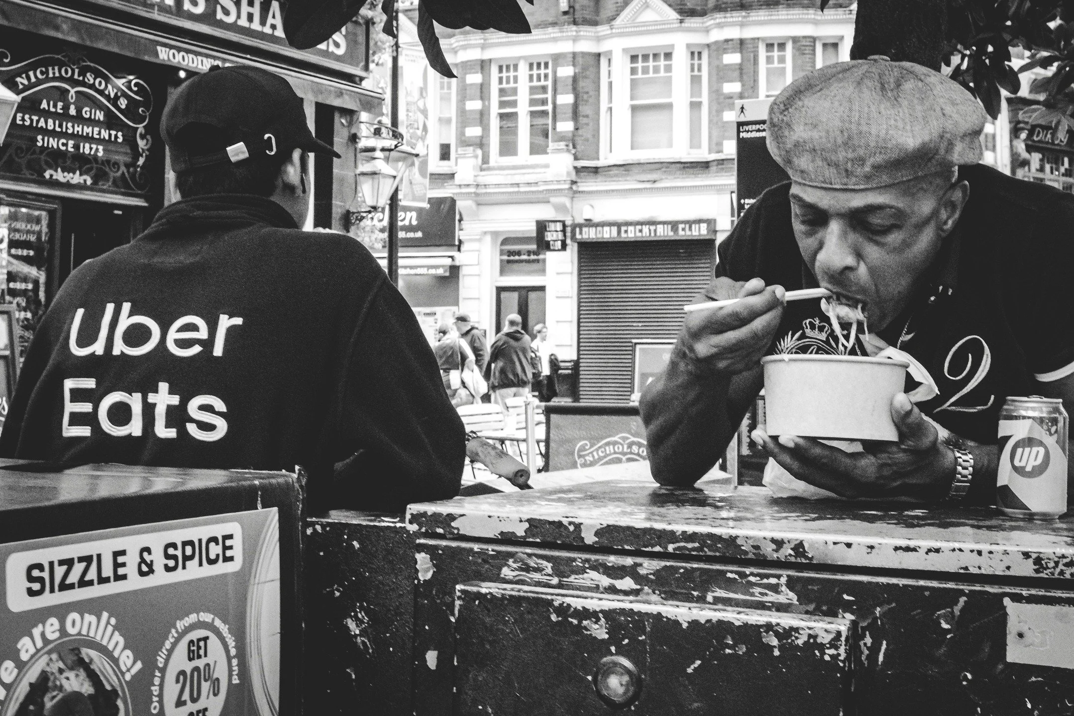 Street food in London is its own performance, quick, messy, and honest.
This isn&rsquo;t posed, it&rsquo;s just what happens when hunger wins and the street becomes the dining room.

#StreetPhotography #DocumentaryPhotography #StreetLife #CandidPhoto
