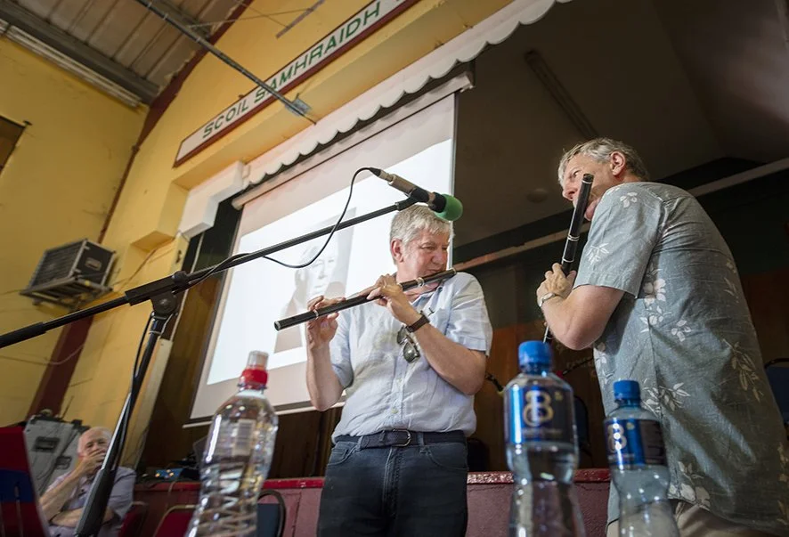 Pádraig Mac Mathúna (centre) playing flute at Harry Bradshaw's lecture about the late broadcaster and collecter Ciarán Mac Mathúna.