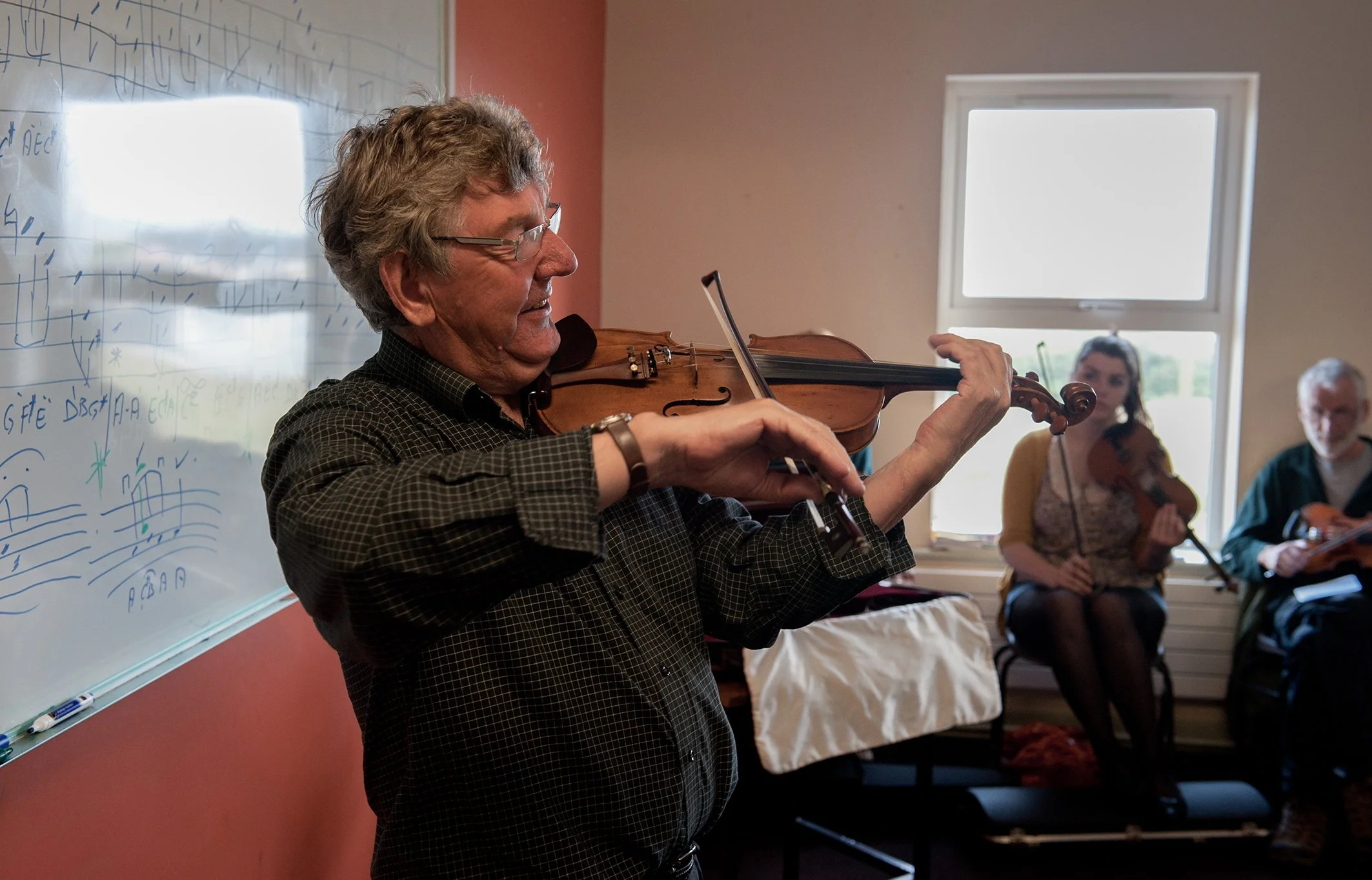 Nickie McAuliffe playing a tune for his fiddle students 2011.