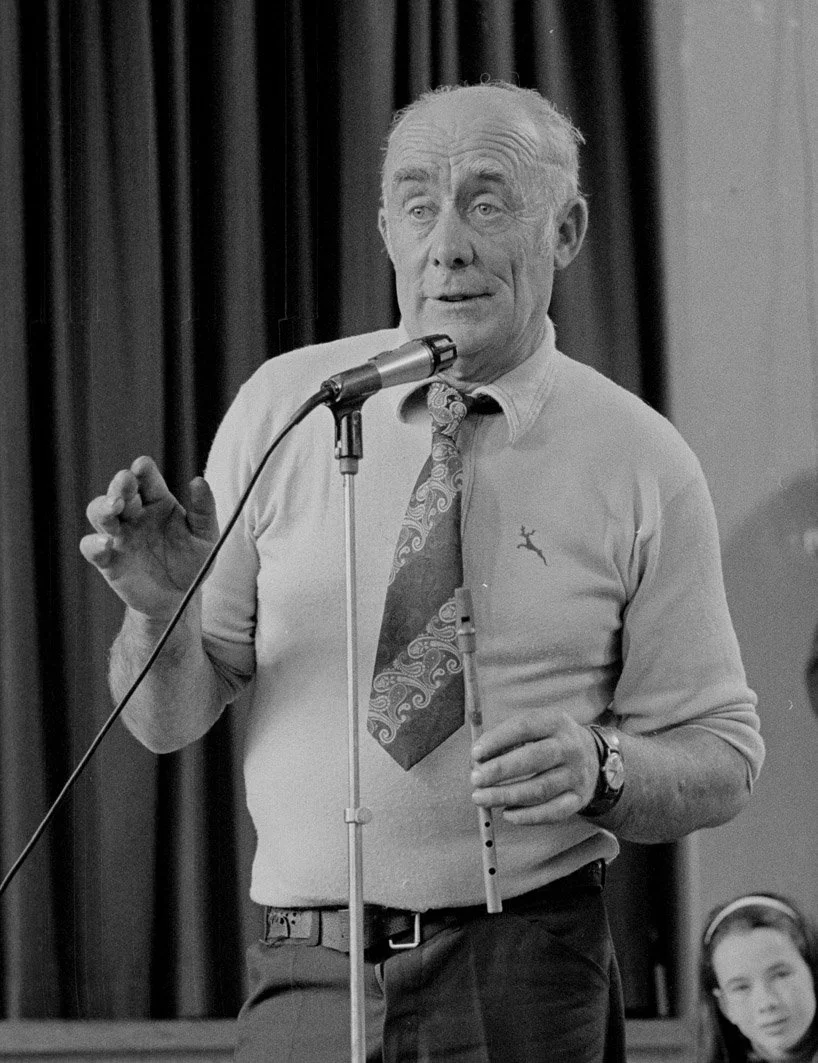 Martin Talty introducing musicians at the tin whistle recital, 1978.