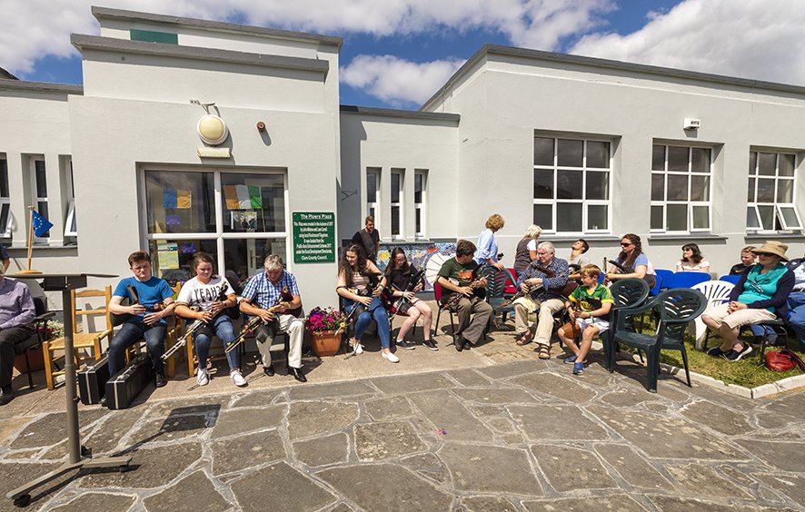 A group of uilleann pipers playing at the opening of the Pipers Plaza.