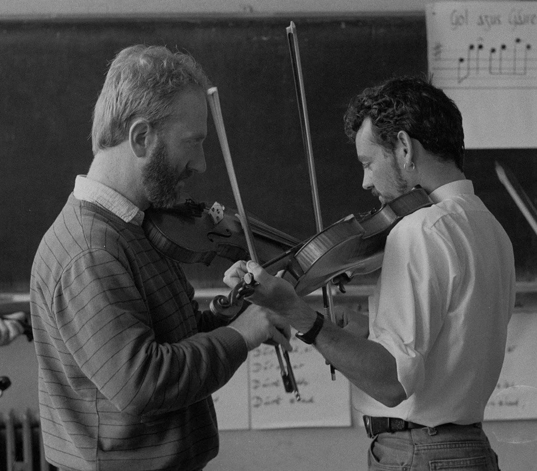 John Kelly Jr. (left) plays a tune with one of his fiddle students, 1985.