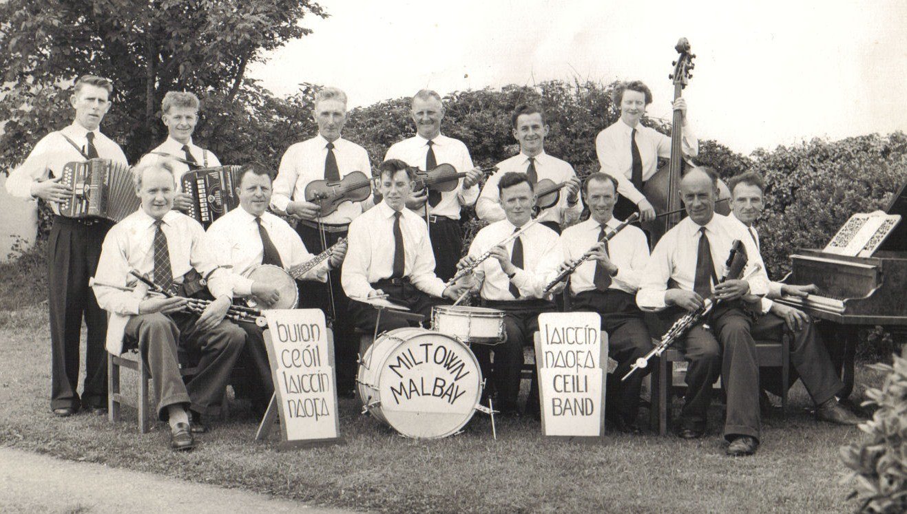 The Laichtín Naofa Céilí Band in the early 1960s. 
Standing left to right - Paddy Joe McMahon, Michael Sexton, Junior Crehan, Paddy Galvin, Christy Dixon, Angela Merry. 
Seated l. to r. - Willie Clancy, Jimmy Ward, Martin Malone, J.C. Talty, Michael 