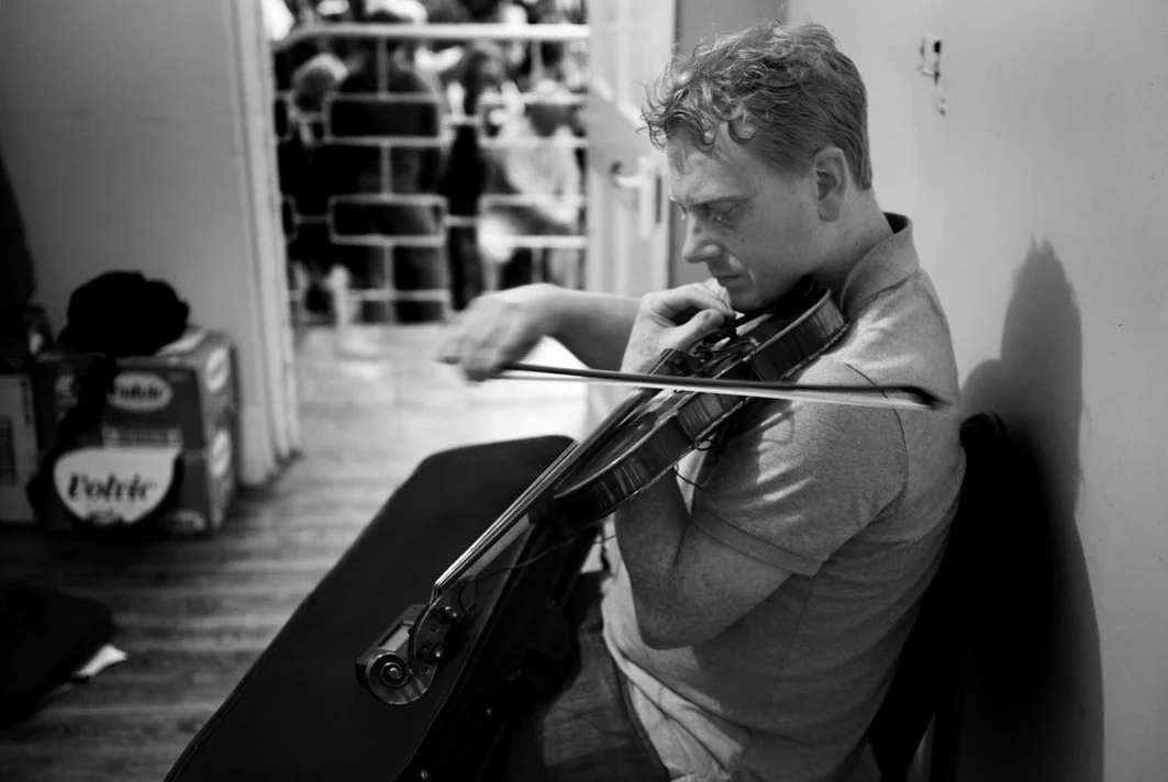 Johnny Kelly tuning up before performing in the fiddle recital, 2009. He is the third generation of the Kelly family to teach and play at the Summer School.