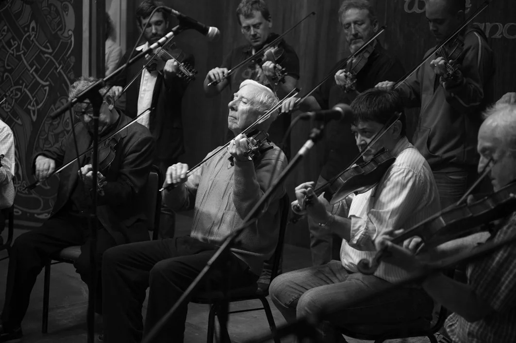 Charlie Lennon (centre) and other fiddle players during the tribute to the late Muiris Ó Rócháin 2012.