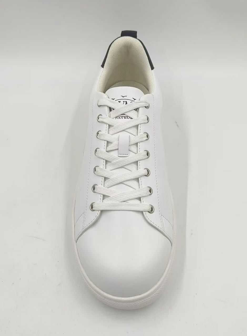 Top view of a white sneaker with white laces and logo on tongue, on a white background.