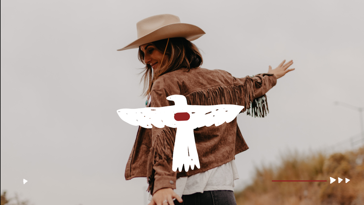 Bailee Buckendorf walking outdoors in a fringe jacket, representing grounded embodiment and resilience