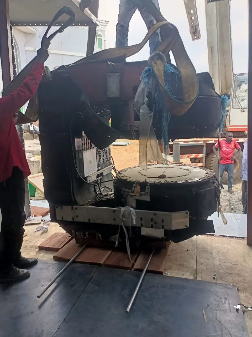 MRI magnet being moved into the scan room on rollers and steel plates