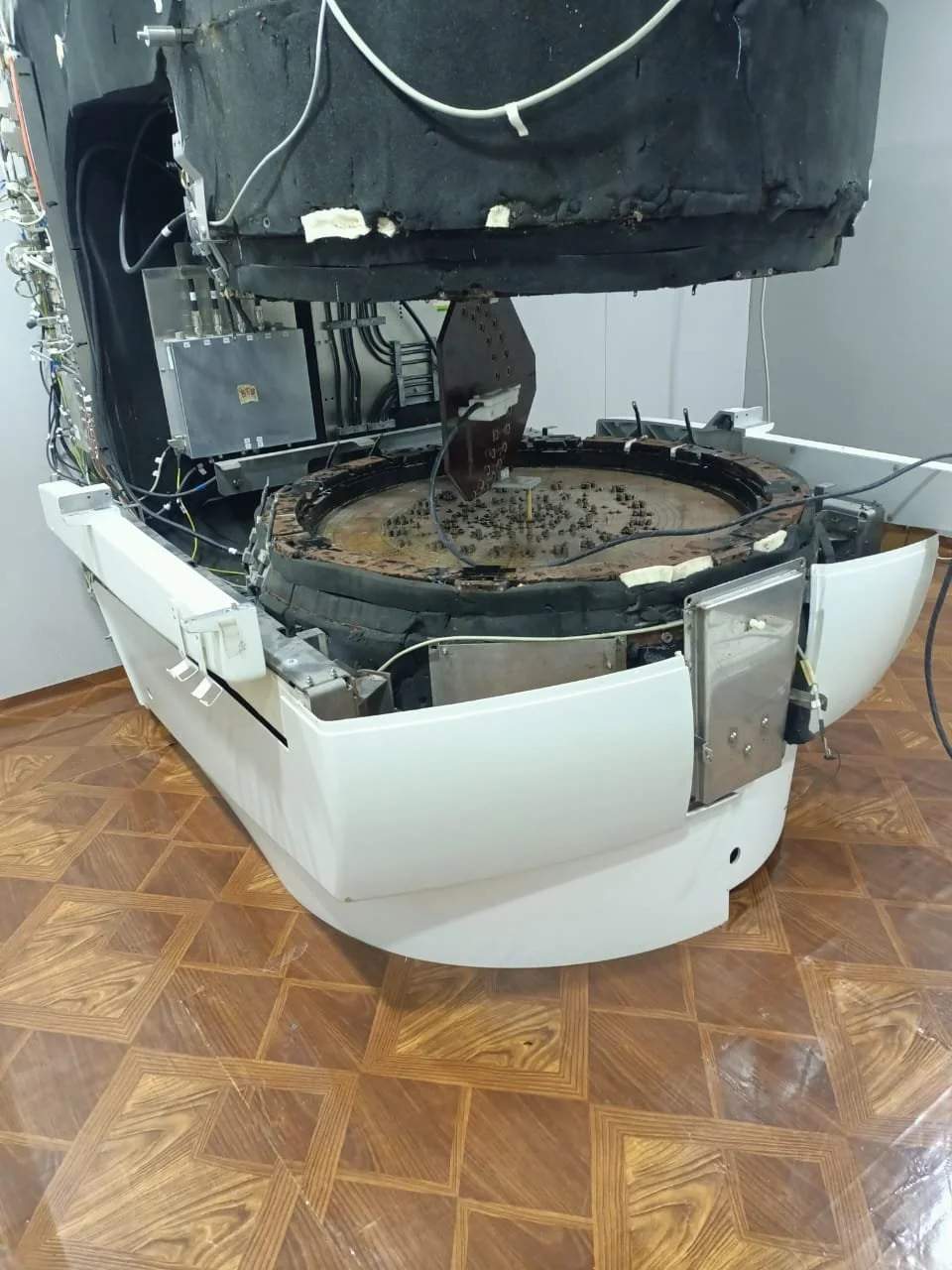 Open MRI magnet during reassembly with covers removed and pole plates exposed