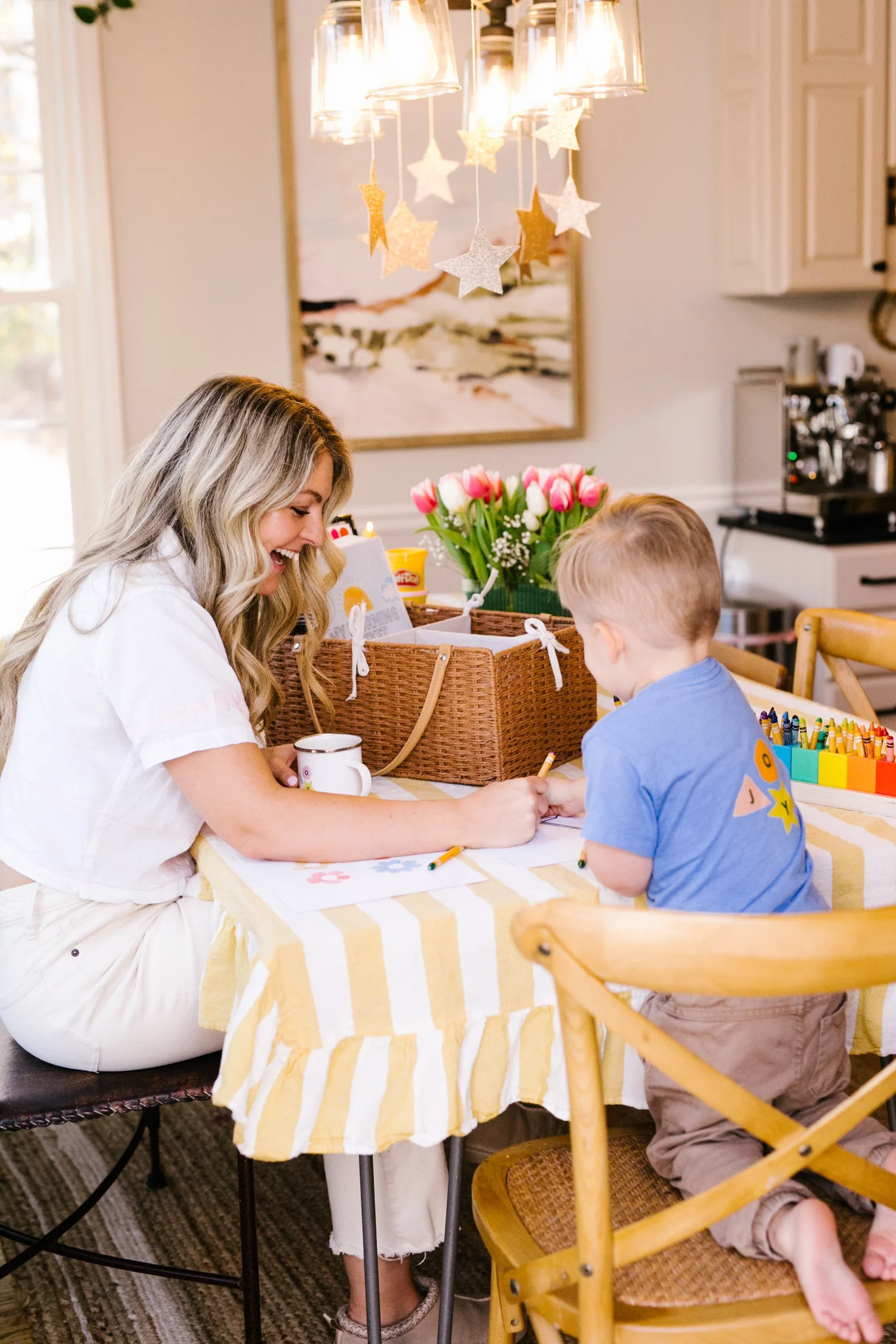 Mom and child doing a morning basket activity together at the kitchen table