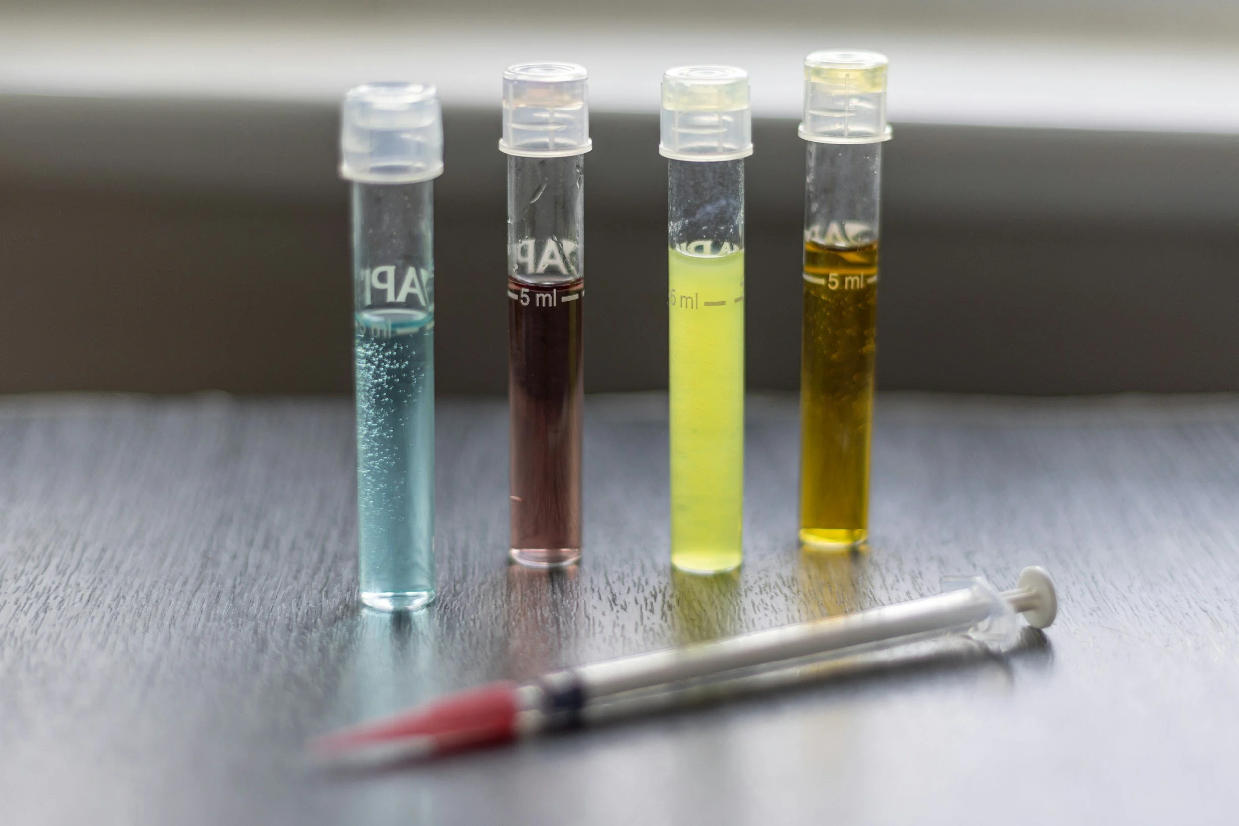 Person lying down with acupuncture needles on neck and cables with clips attached to acupuncture points.