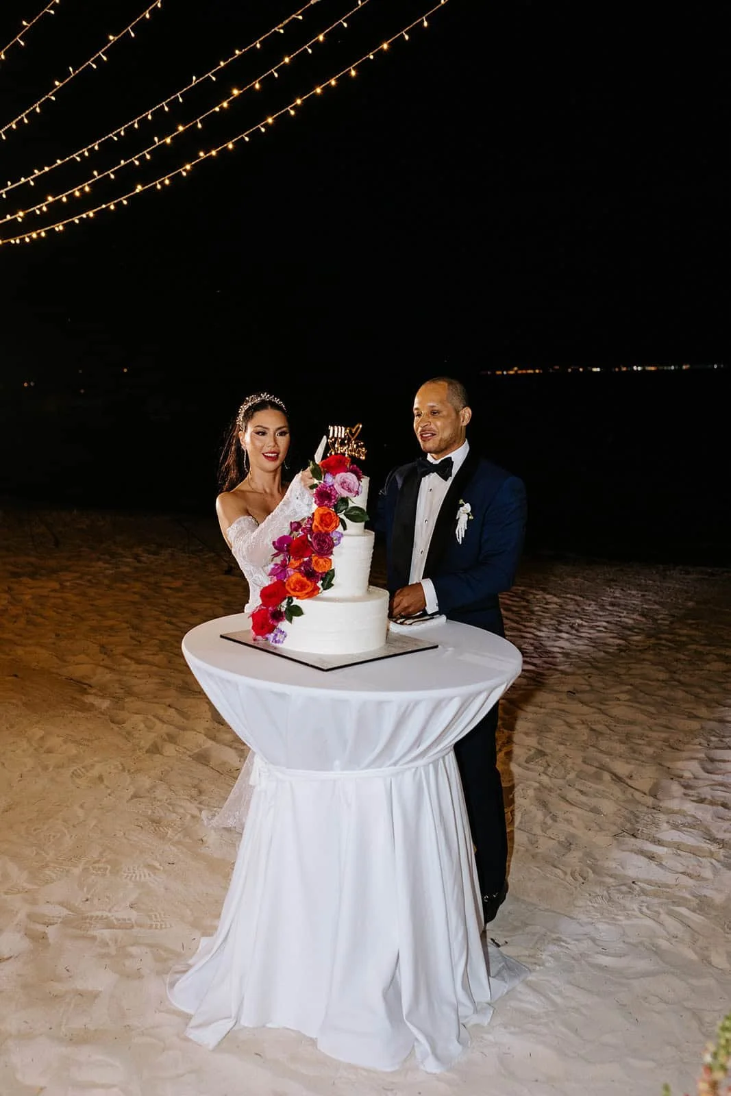 garza-blanca-cancun-wedding-cake-cutting-beach-night.jpg