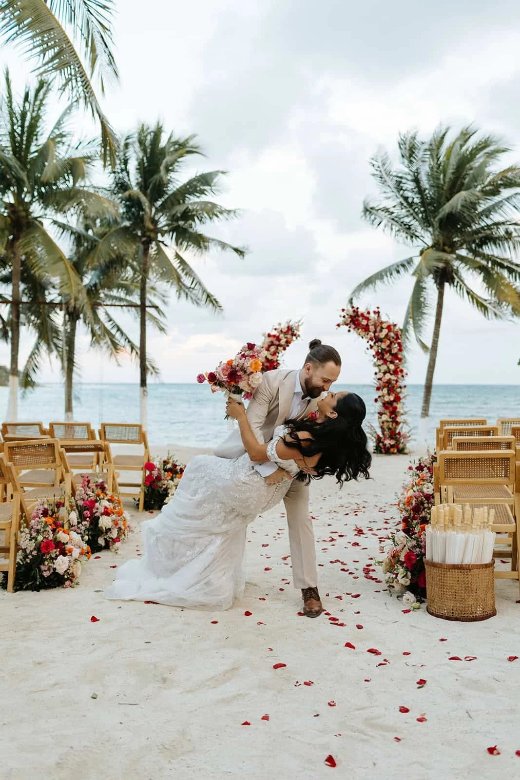 bride-groom-dip-kiss-blue-venado-beach-ceremony-riviera-maya.jpg