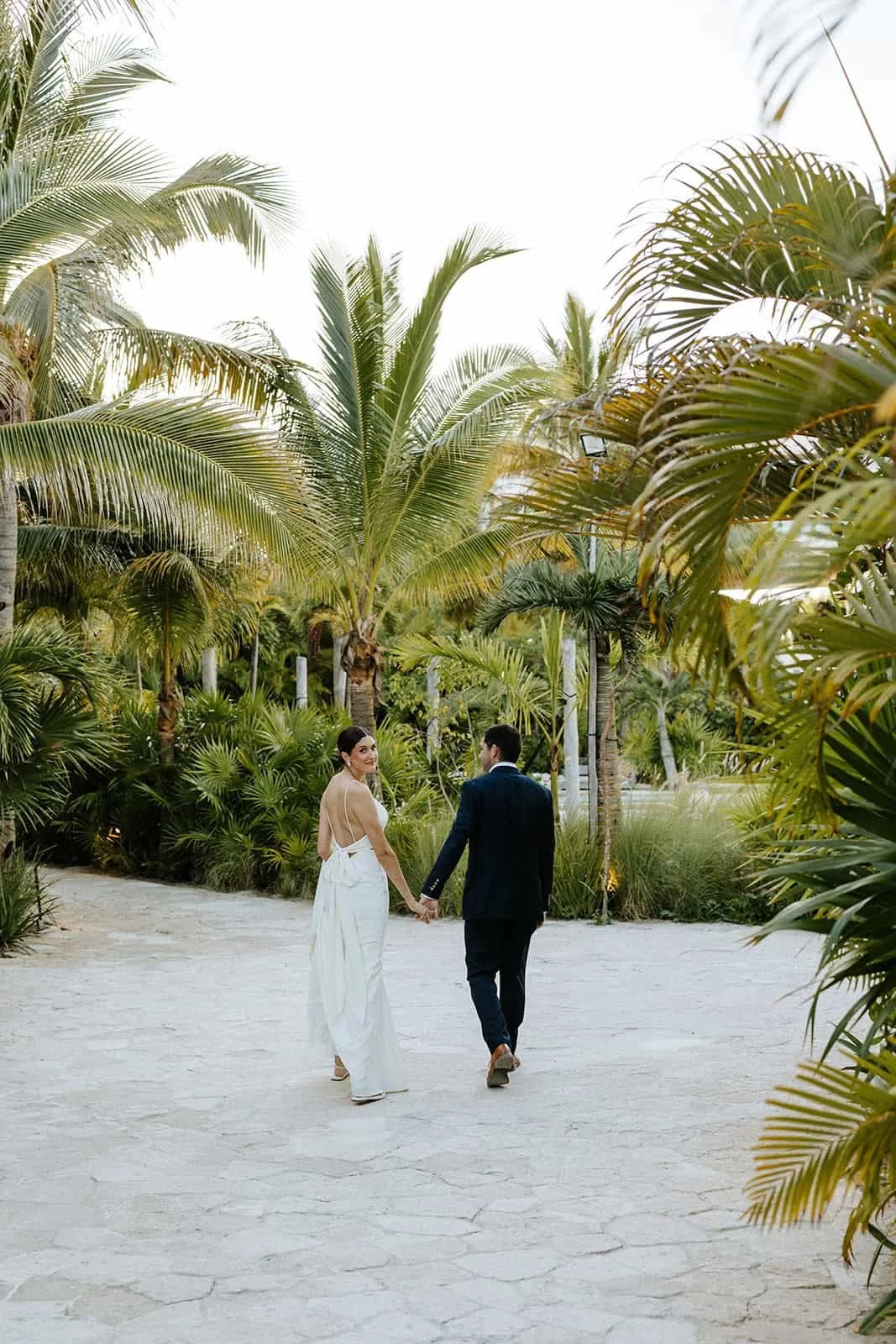 secrets-moxche-wedding-couple-walking-palms.jpg