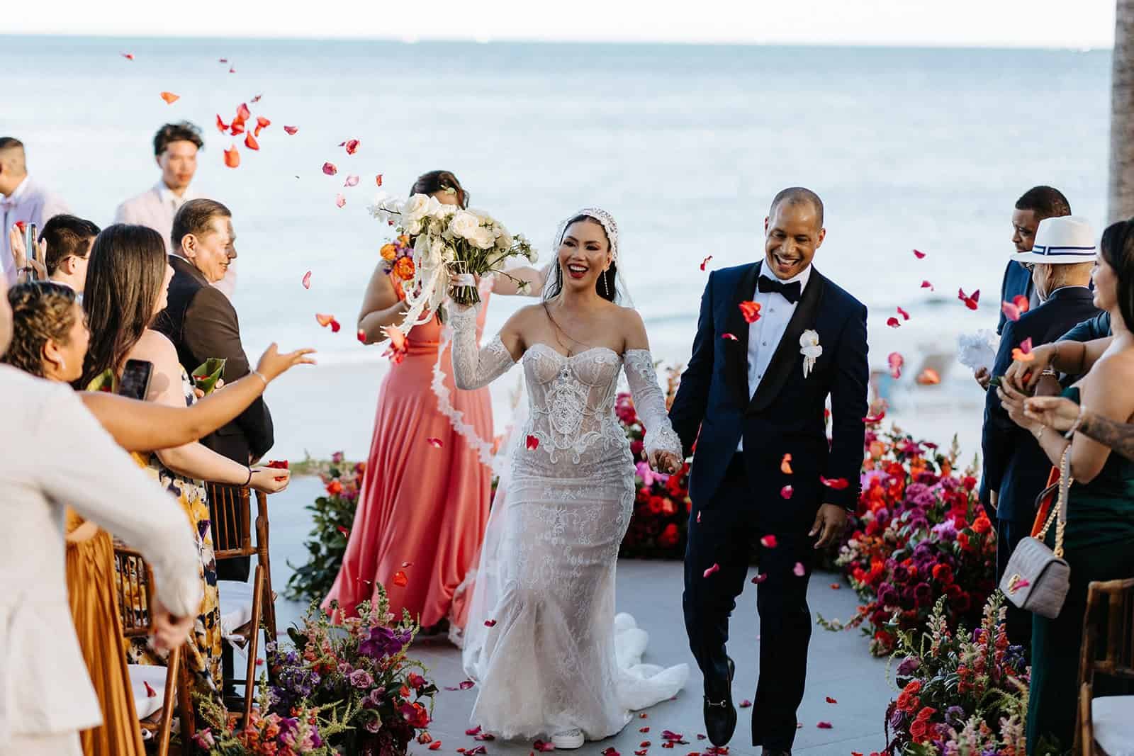 Couple walking down the aisle after their wedding ceremony at Garza Blanca Cancun overlooking the Caribbean Sea