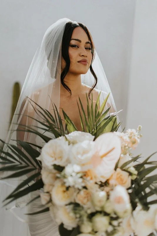 Bride holding a tropical bouquet during a Cancun destination wedding.