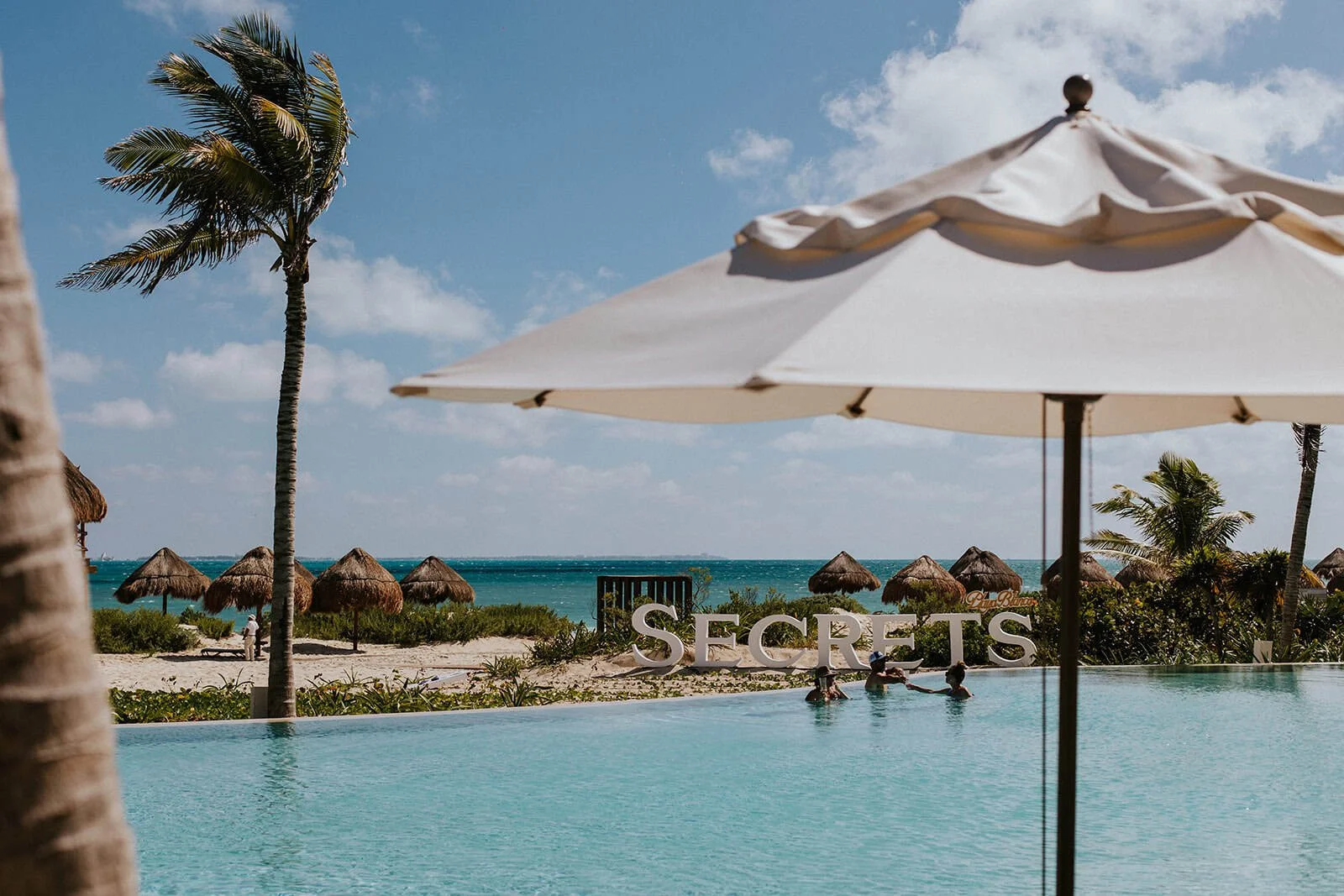 View from the pool looking out toward the ocean at Secrets Playa Blanca Costa Mujeres