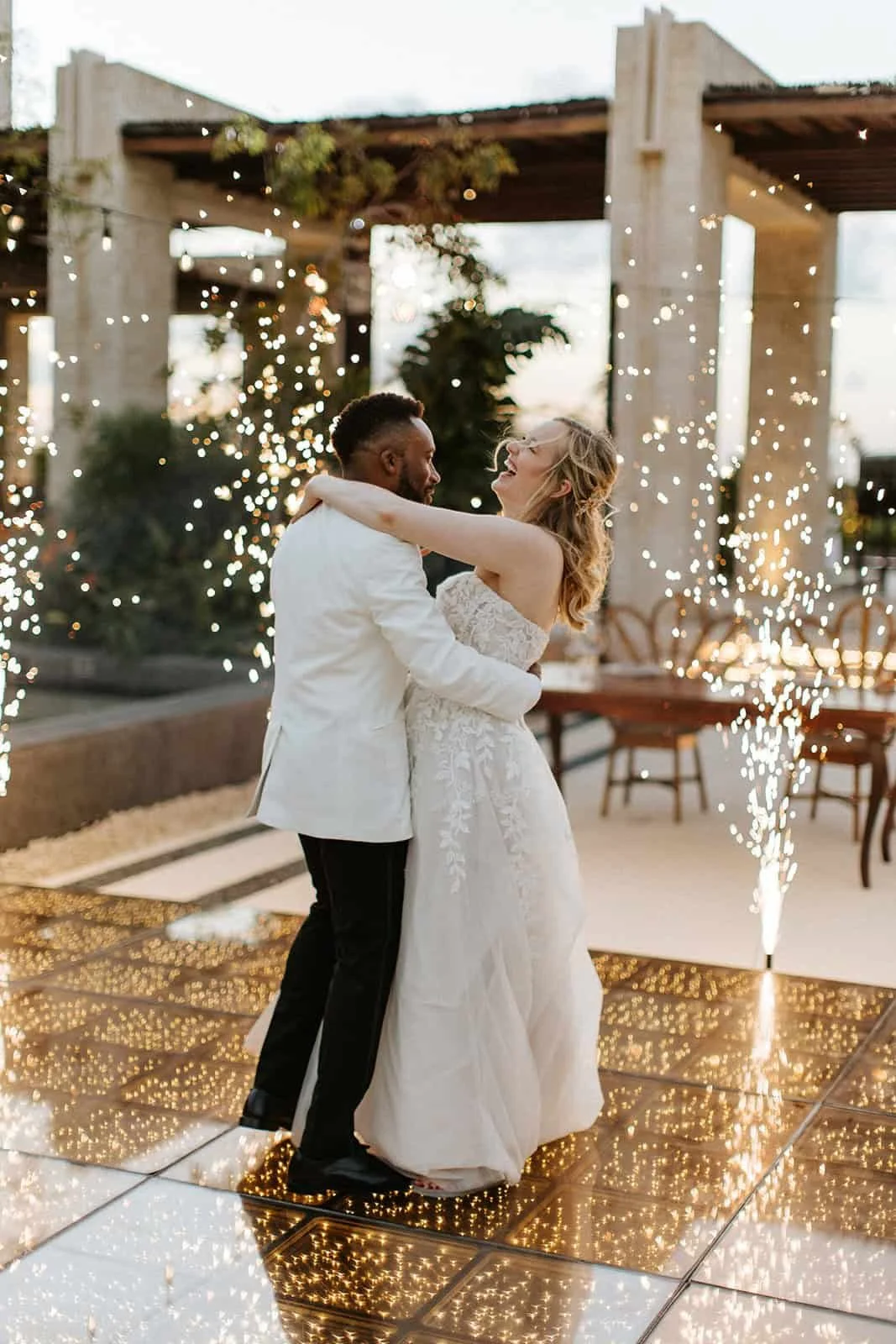 Bride and groom dancing with sparklers during luxury destination wedding in Mexico