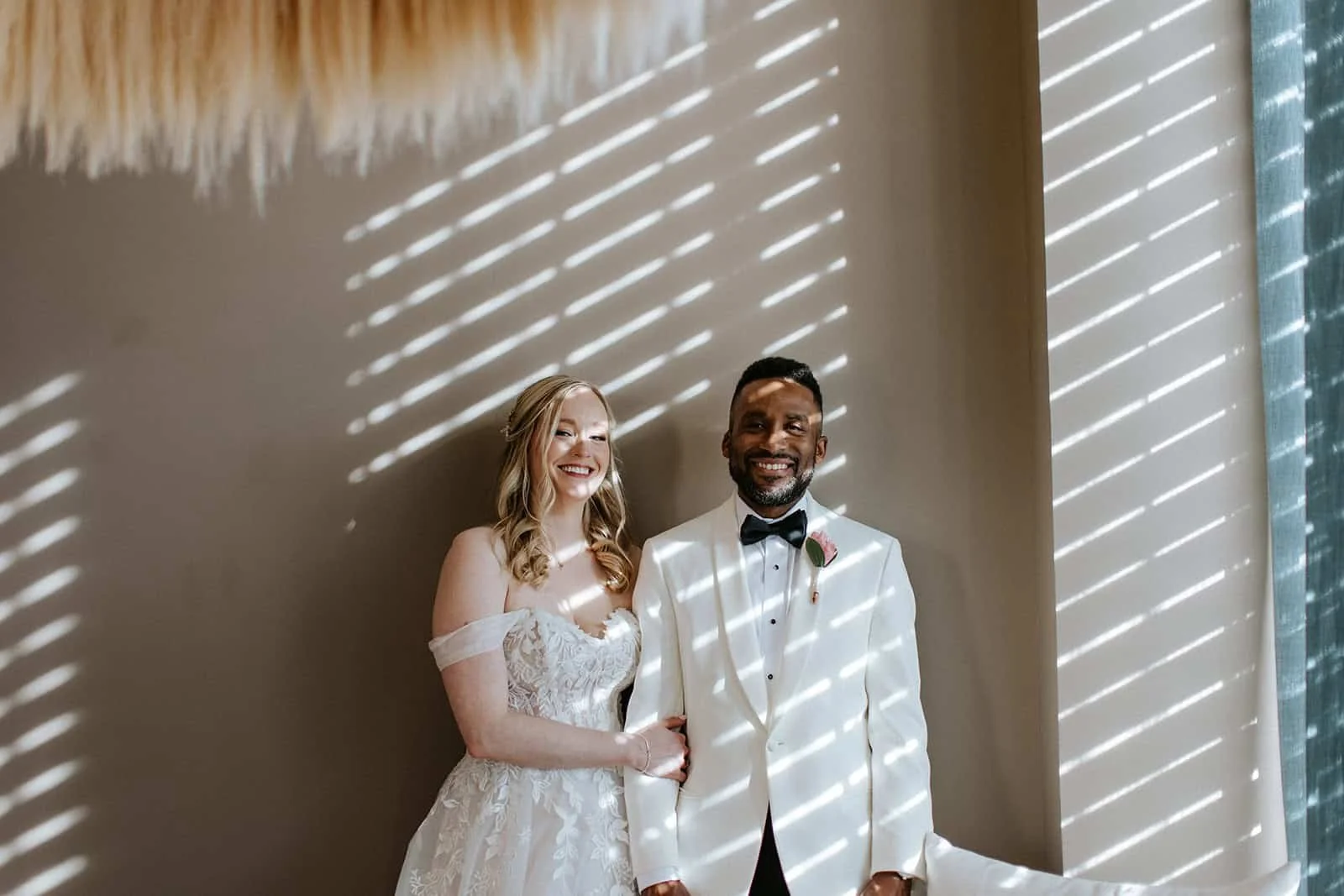 Bride and groom smiling in striped light and shadow at Secrets Playa Blanca Costa Mujeres