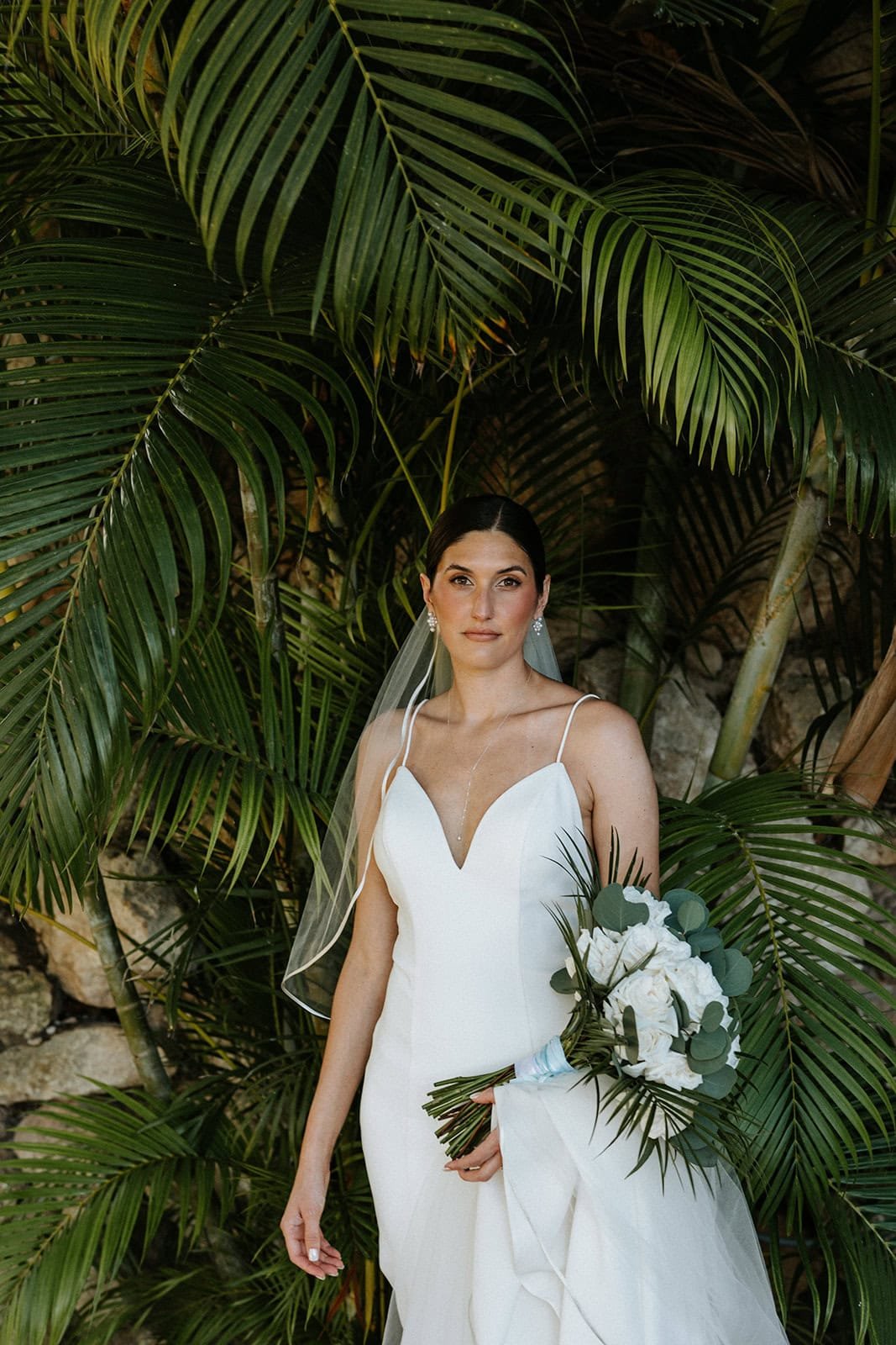Bride portrait in tropical setting during destination wedding in Riviera Maya Mexico