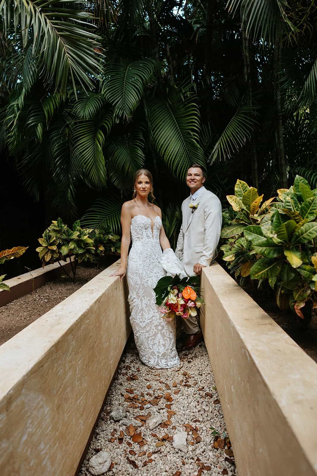 Bride and groom portrait in tropical jungle at Riviera Maya destination wedding in Mexico
