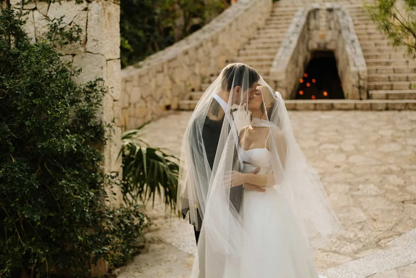 xcaret-park-wedding-couple-veil-kiss.jpg