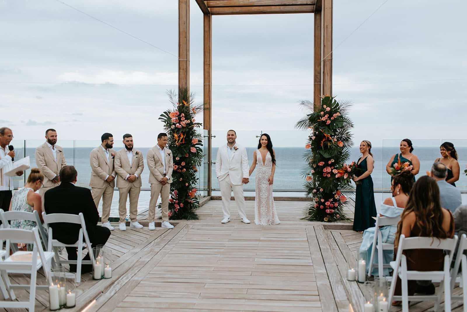 edding ceremony at the Sky Rooftop Gazebo at Secrets Moxché Playa del Carmen, couple standing beneath the wooden gazebo with the ocean behind them