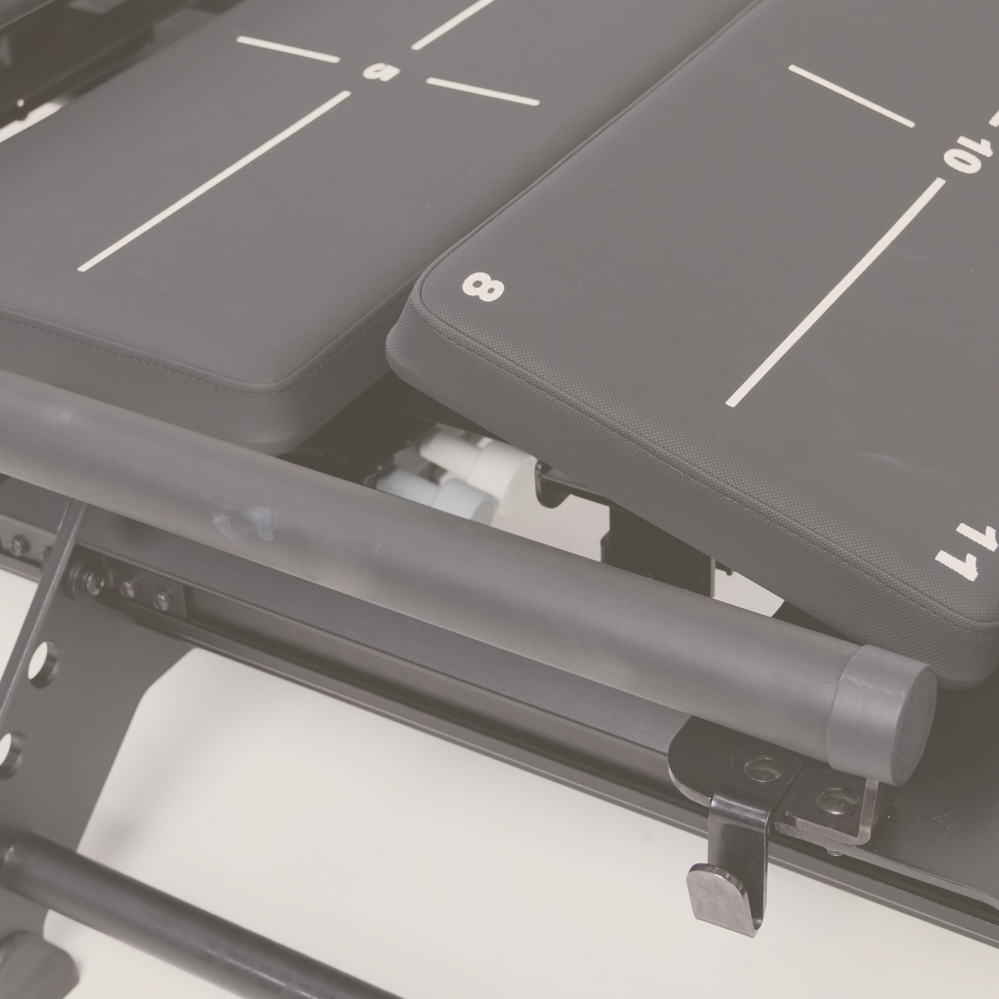 Close-up of an anti-gravity exercise treadmill showing padded supports with numbered markings and a metallic frame