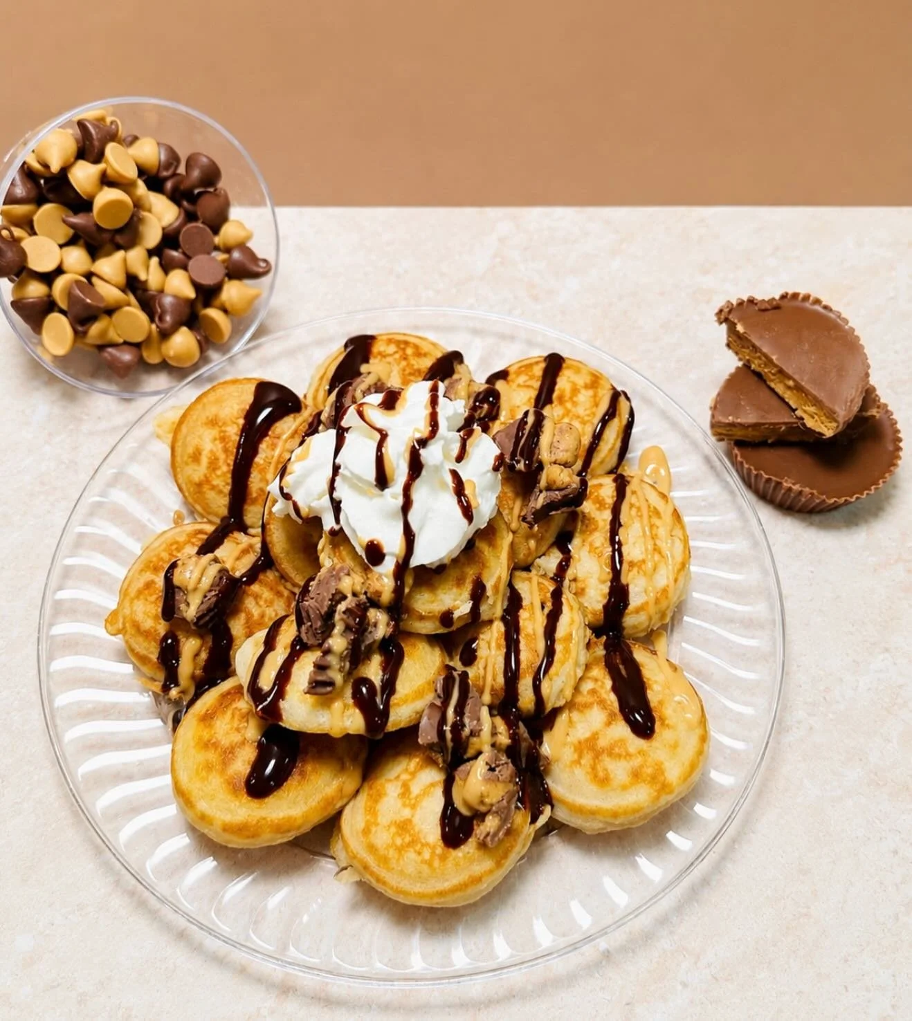 The Perfect Pair 🤎 Peanut butter and chocolate chip pancakes with creamy, decadent toppings.

This tasty stack is topped with peanut butter syrup, chocolate syrup, whipped cream, and crushed Reese&rsquo;s cups🤤

#minipancakes #dmvfoodie #dmvtreats