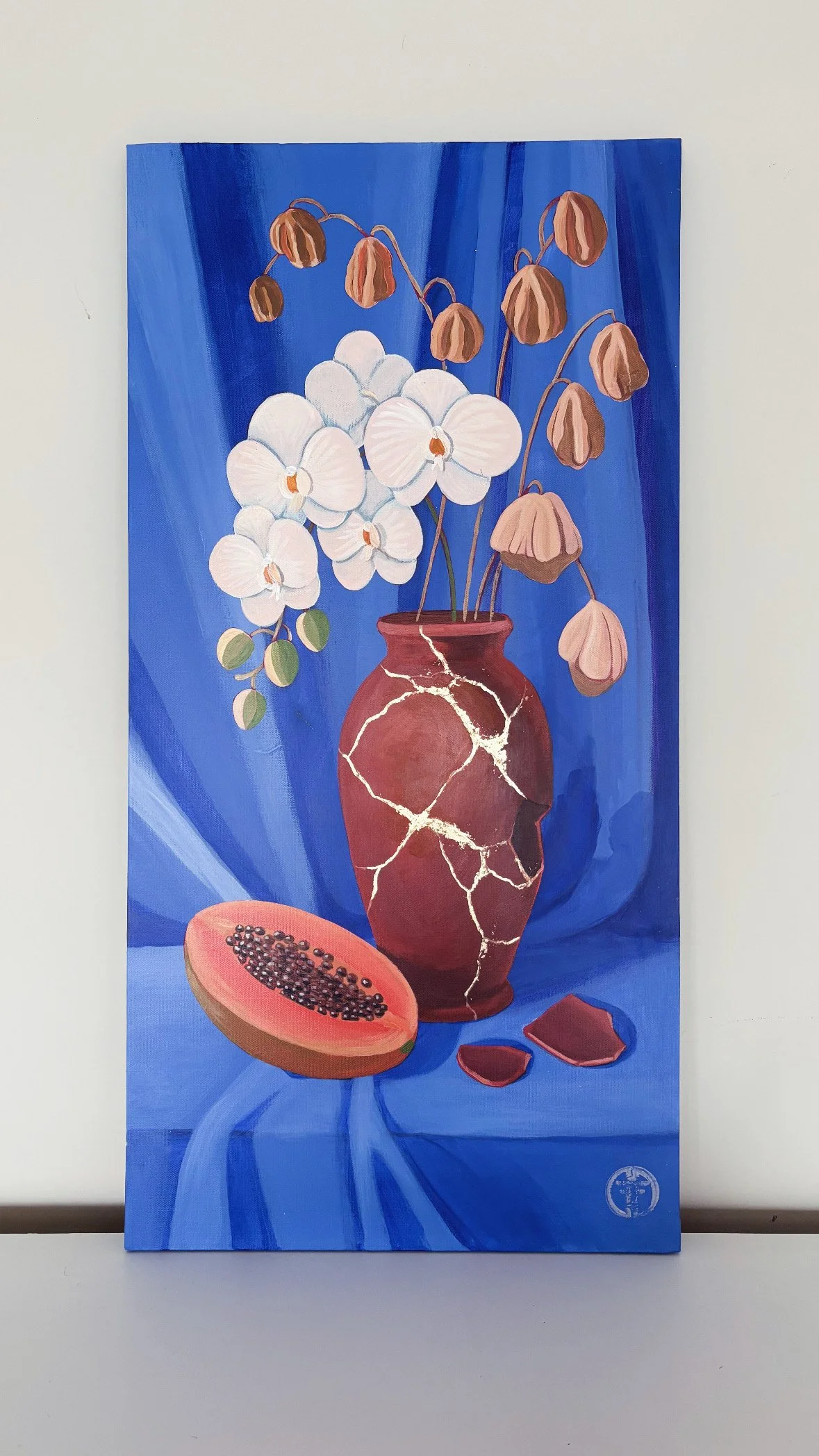 Painting of white orchids in a cracked brown vase against a blue background with a halved papaya and pieces of chocolate.