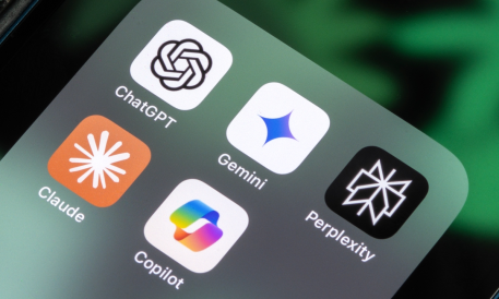 Smartphone screen showing app icons for leading AI platforms: ChatGPT, Gemini, Claude, Copilot, and Perplexity.