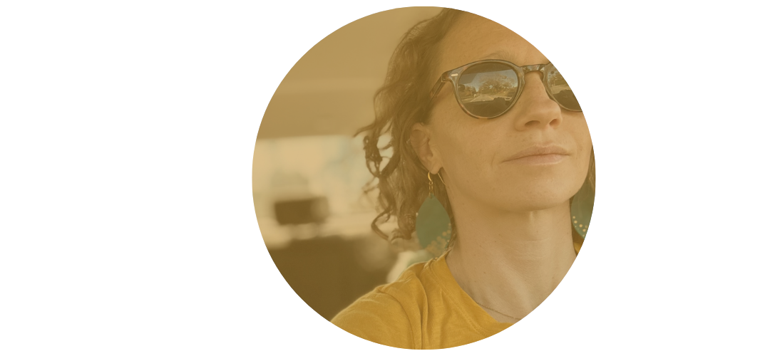 Burnout recovery coach wearing sunglasses and a yellow shirt, inside a vehicle with a blurred background.