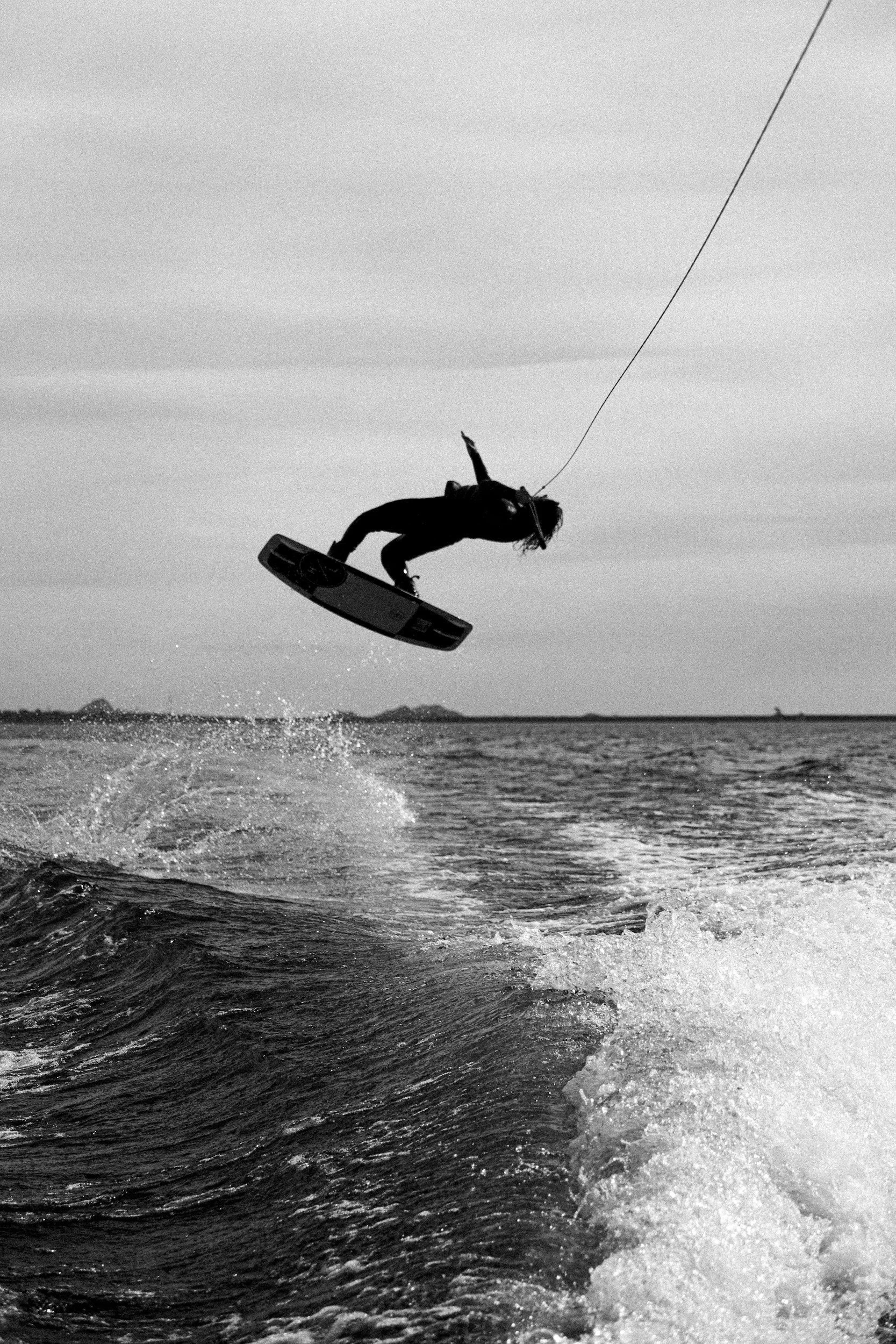 Person wakeboarding, performing a jump